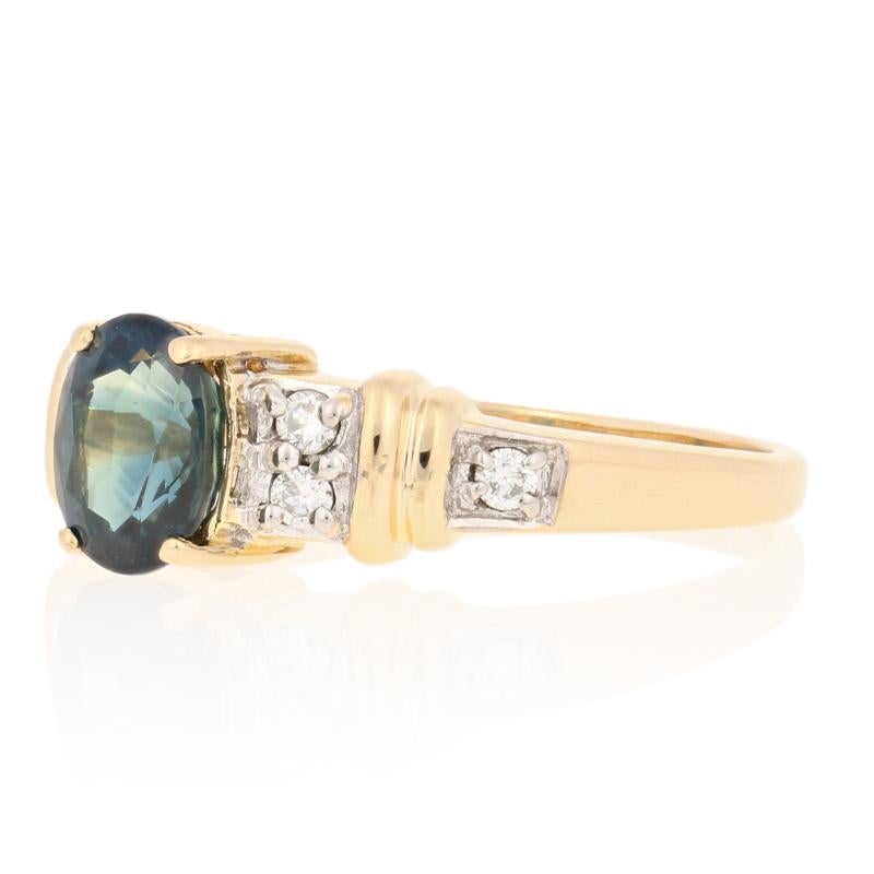 Elegant and refined, this ring will be a beautiful addition to your jewelry collection! This 18k yellow and white gold piece showcases a majestic blue sapphire accompanied by six sparkling diamonds.  

This ring is a size 9 1/2, but it can be