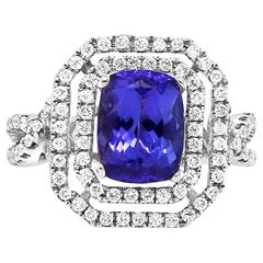 1.99 Carat Emerald Cut Tanzanite and 0.65 Carat White Diamond Ring 18 Karat Gold 1.99 Carat Emerald Cut Tanzanite and 0.65 Carat White Diamond Ring 18 Karat Gold