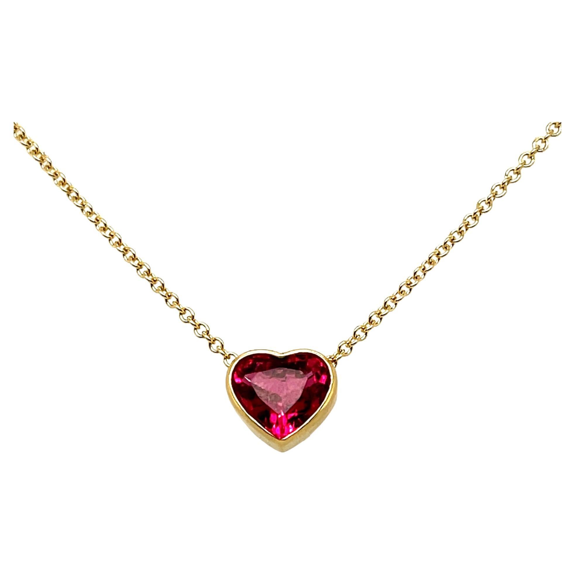 This gorgeous heart-shaped pink rubellite tourmaline necklace is simply dazzling! It features a 1.99 carat striking gem with vivid hot pink color, set in a custom-made 18k yellow gold bezel and suspended on a classic and elegant 18k yellow gold