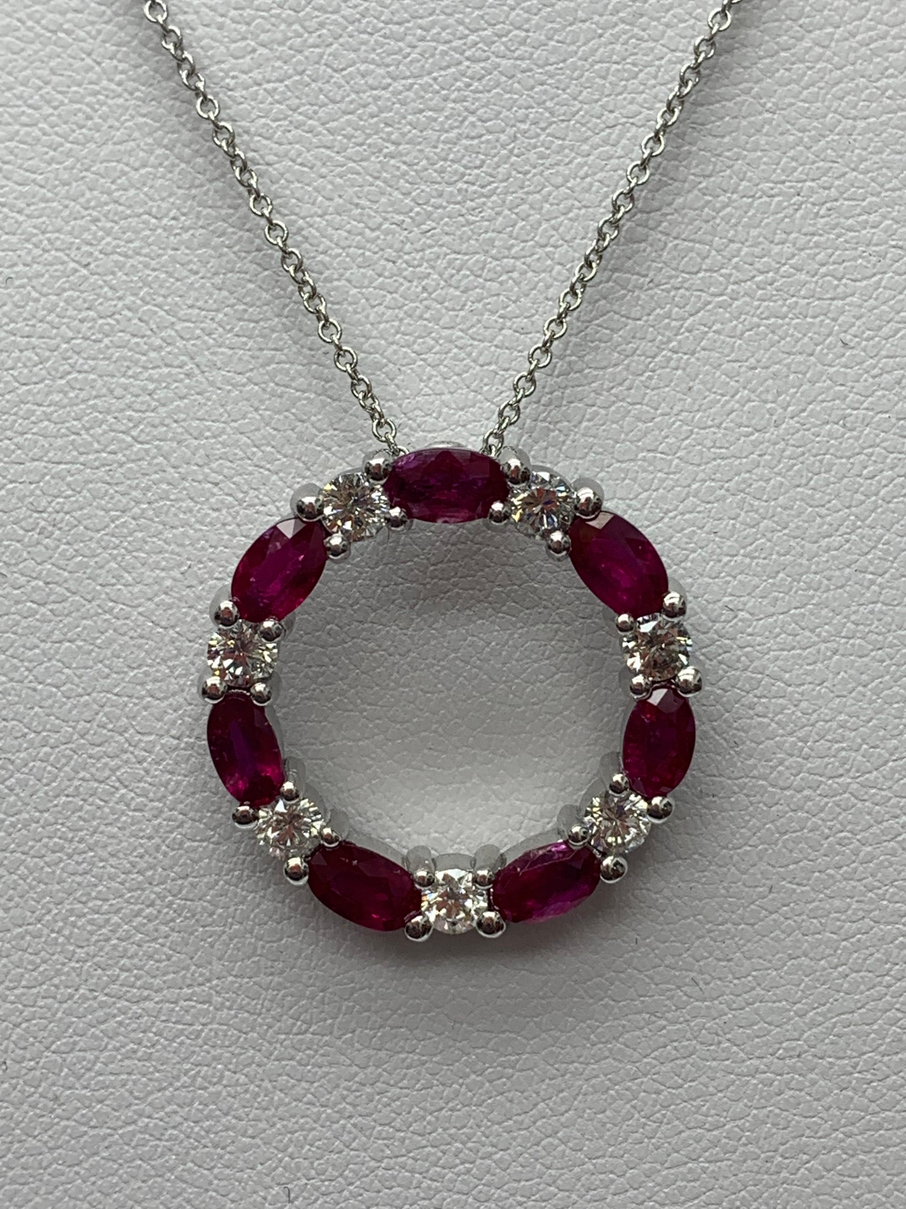 A stylish pendant necklace showcasing a row of rubies alternating diamonds, set in an open-work, circular design. 7 oval shape rubies weigh 1.99 carats and 7 brilliant-cut diamonds weigh 0.71 carats in total. All diamonds are GH color SI1 Clarity.