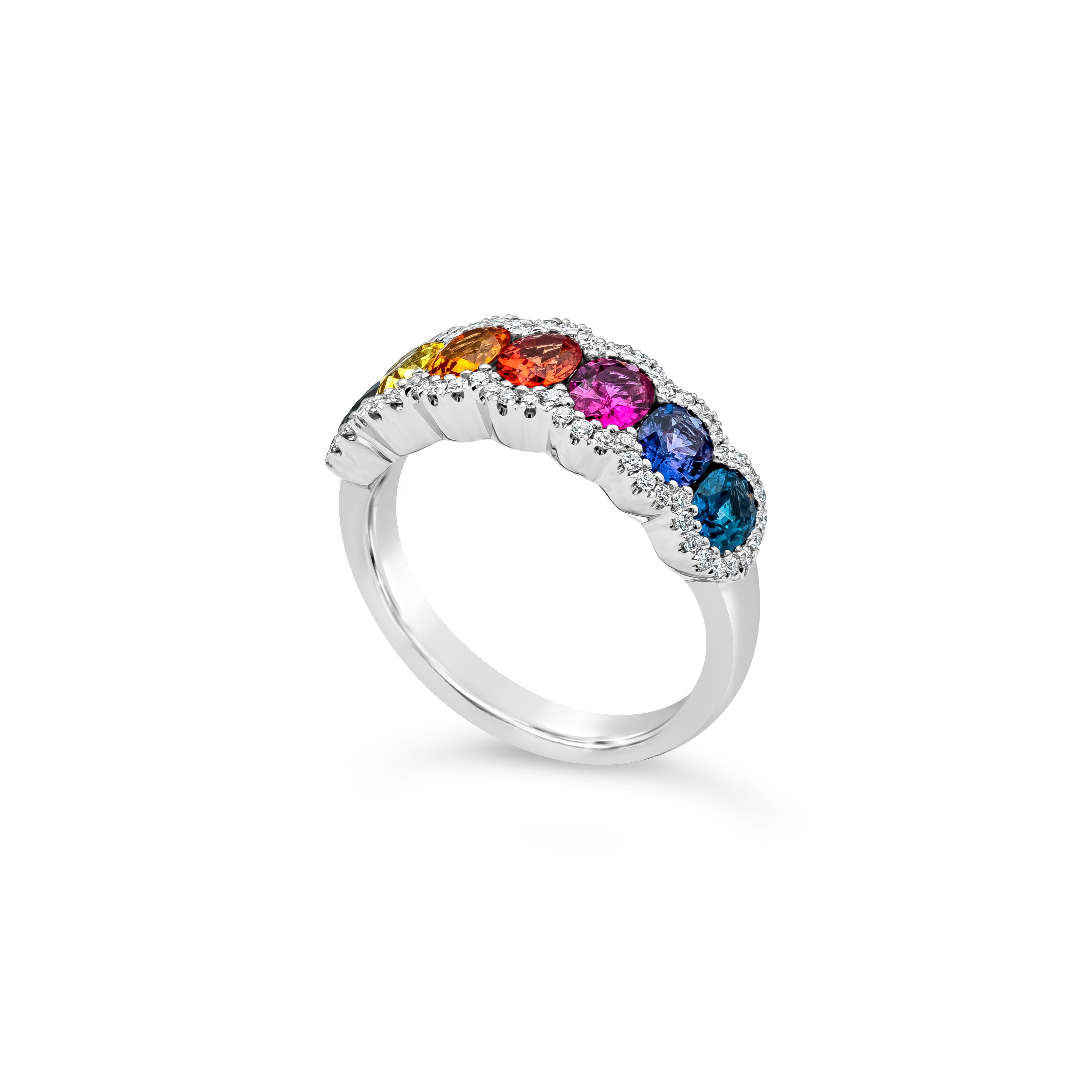 This chic and stylish fashion ring showcases seven multi color oval cut sapphires surrounded with white round brilliant diamonds. Sapphires weighs 1.99 carats total. Accents diamonds weighs 0.23 carats total, F-G Color and VS-SI in Clarity. Made