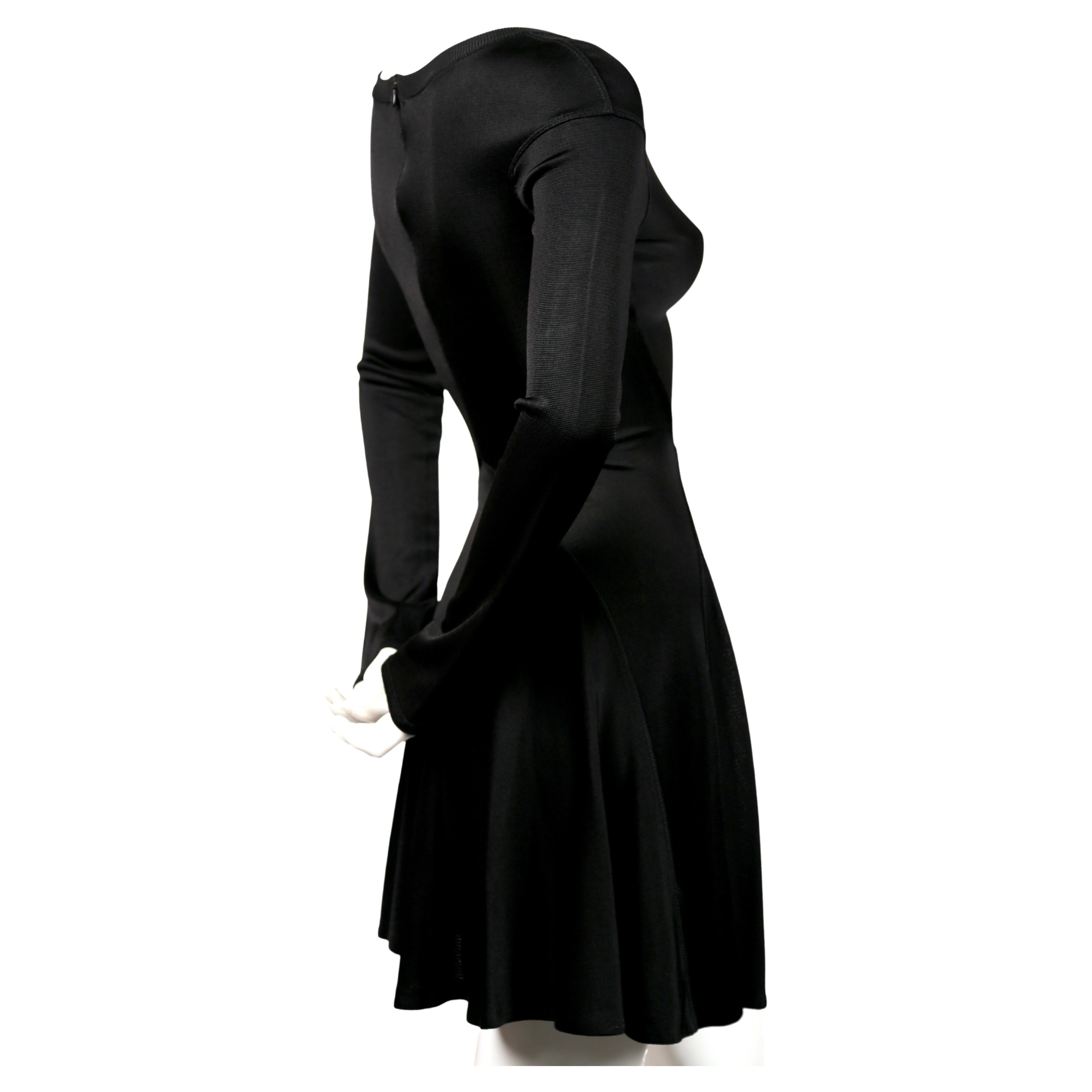 Incredibly flattering, jet-black, seamed dress with full skirt from Azzedine Alaia dating to approximately 1990. Size XS. Approximate measurements (unstretched): drop shoulder 17