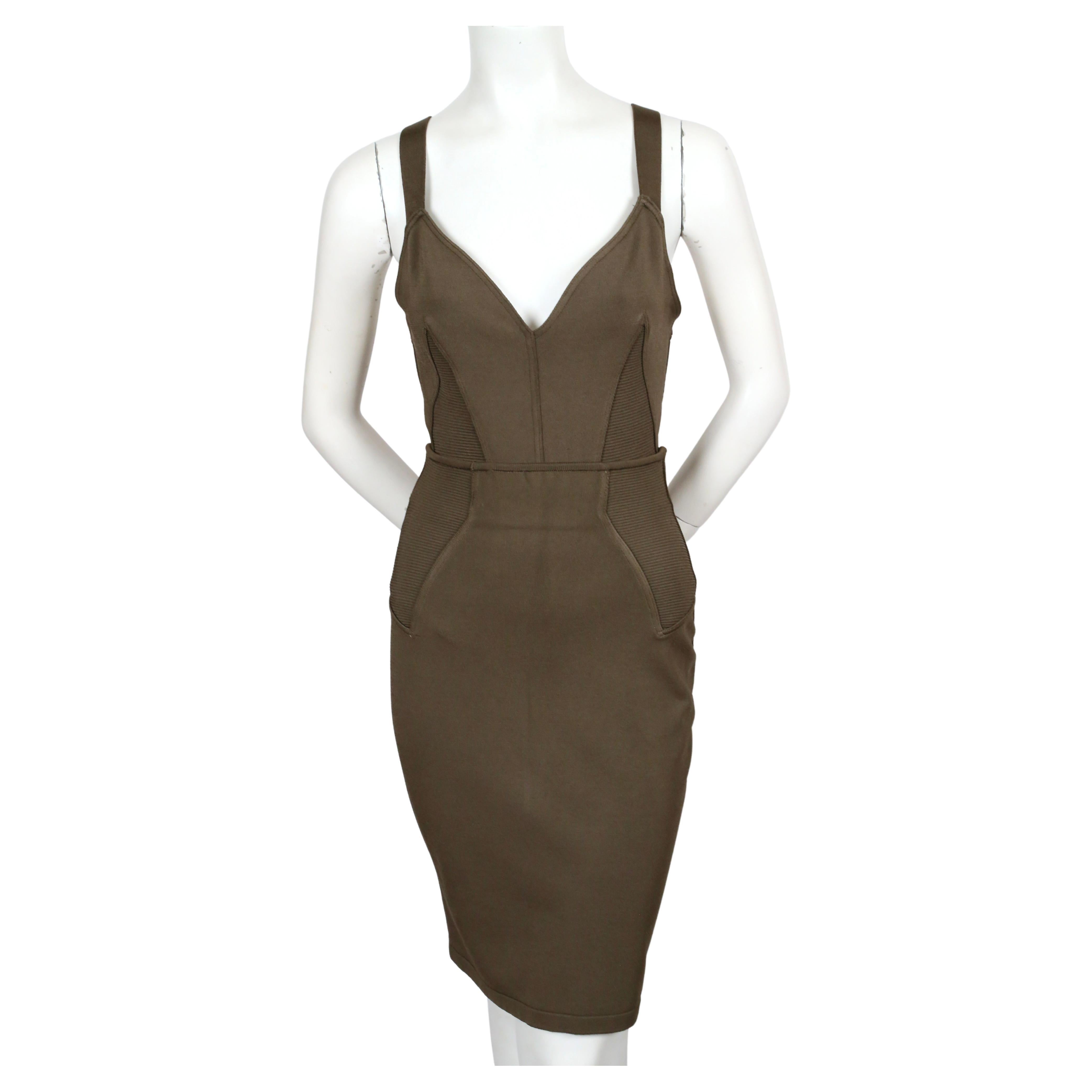Khaki viscose bodysuit and matching skirt with cleverly placed ribbed inserts designed by Azzedine Alaia, dating to spring of 1990 as seen on the runway in white. No size indicated. Best fits a US 4-6. Approximate measurements of bodysuit