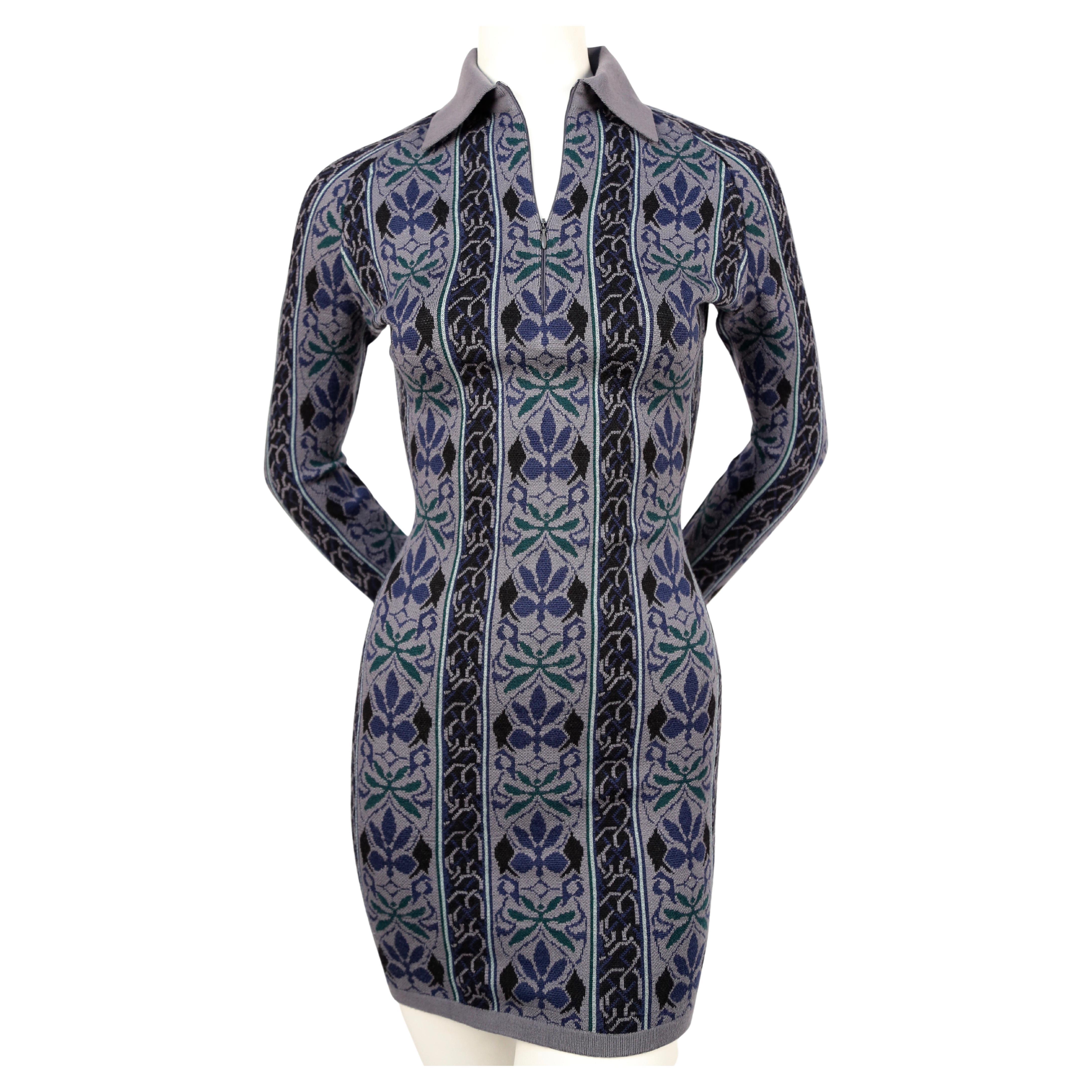 Very rare, blue knit dress with woven abstract floral motif designed by Azzedine Alaia dating to fall of 1990 exactly as seen on the runway. Dress is labeled a size S. Approximate measurements (unstretched): shoulder 14