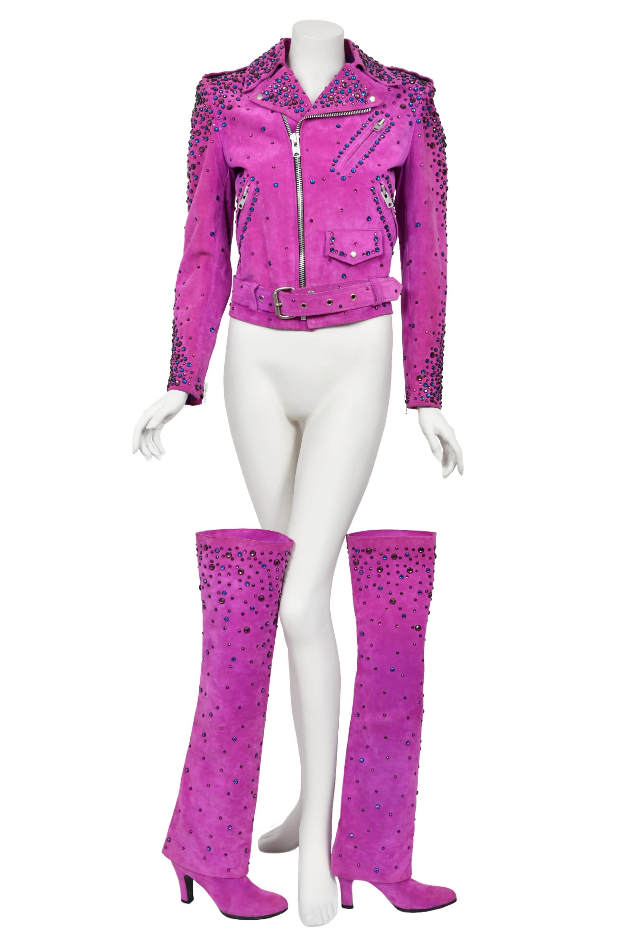 An important, one-of-a-kind Bob Mackie couture fuchsia pink suede motorcycle jacket with matching over-the-knee boots custom made for his dear friend, Cher. We were thrilled to find an image of Cher in her closet holding this exact jacket in hand.