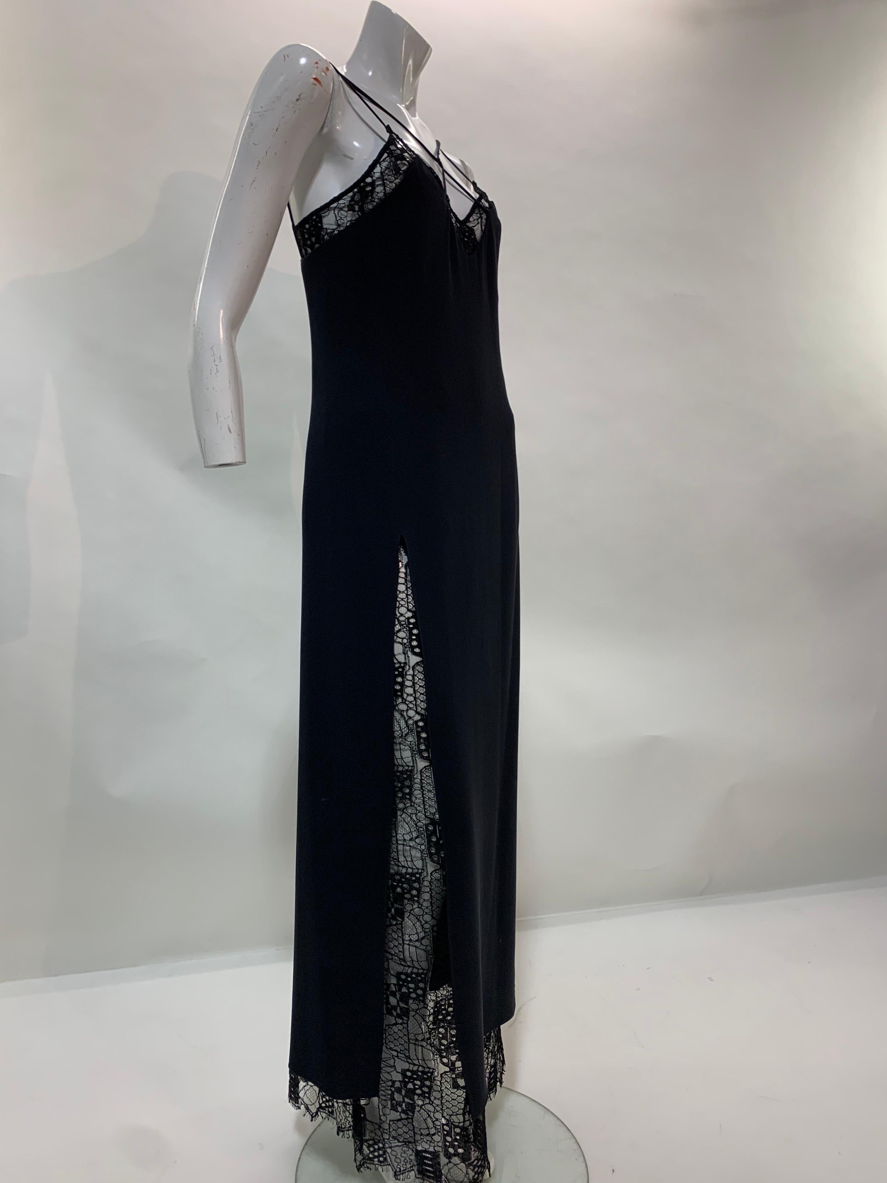A beautiful and sexy 1990s Christian Lacroix classic black evening gown: under-layer is French silk lace to the floor. Over-layer is black silk crepe that features crossed spaghetti straps and a deep side slit. Size EU 40
