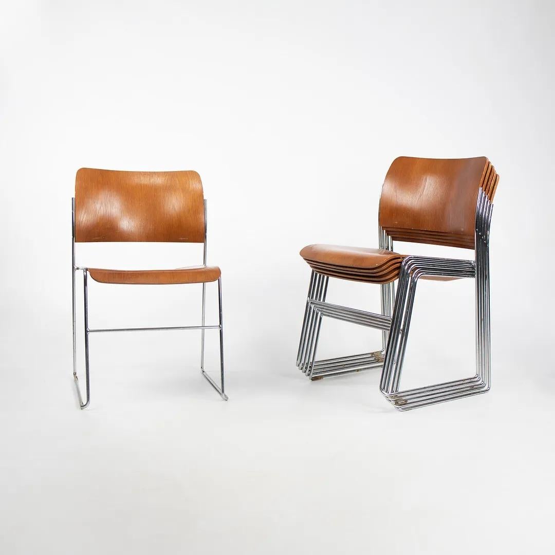 These are '40/4' chairs, originally designed by David Rowland in 1964. This iconic chair has been praised as one of the most ingenious modern designs of the 20th century, and is credited as the first truly stackable chair. The listed price includes