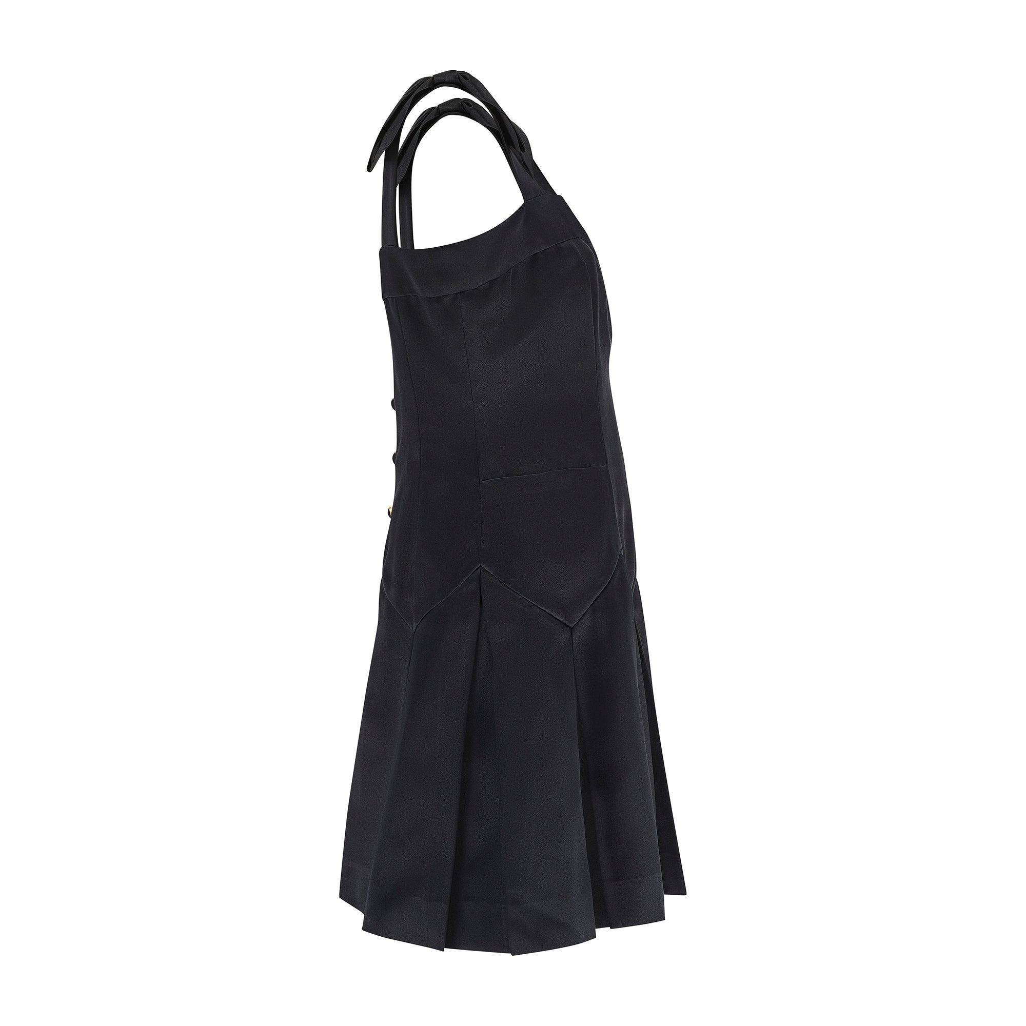 This documented mini-dress was made by Chanel for the Fall 1990 ready to wear collection.  We have attached editorial shots of the advanced collection with a short sleeve version; the runway has the dress strapless and paired with elbow length