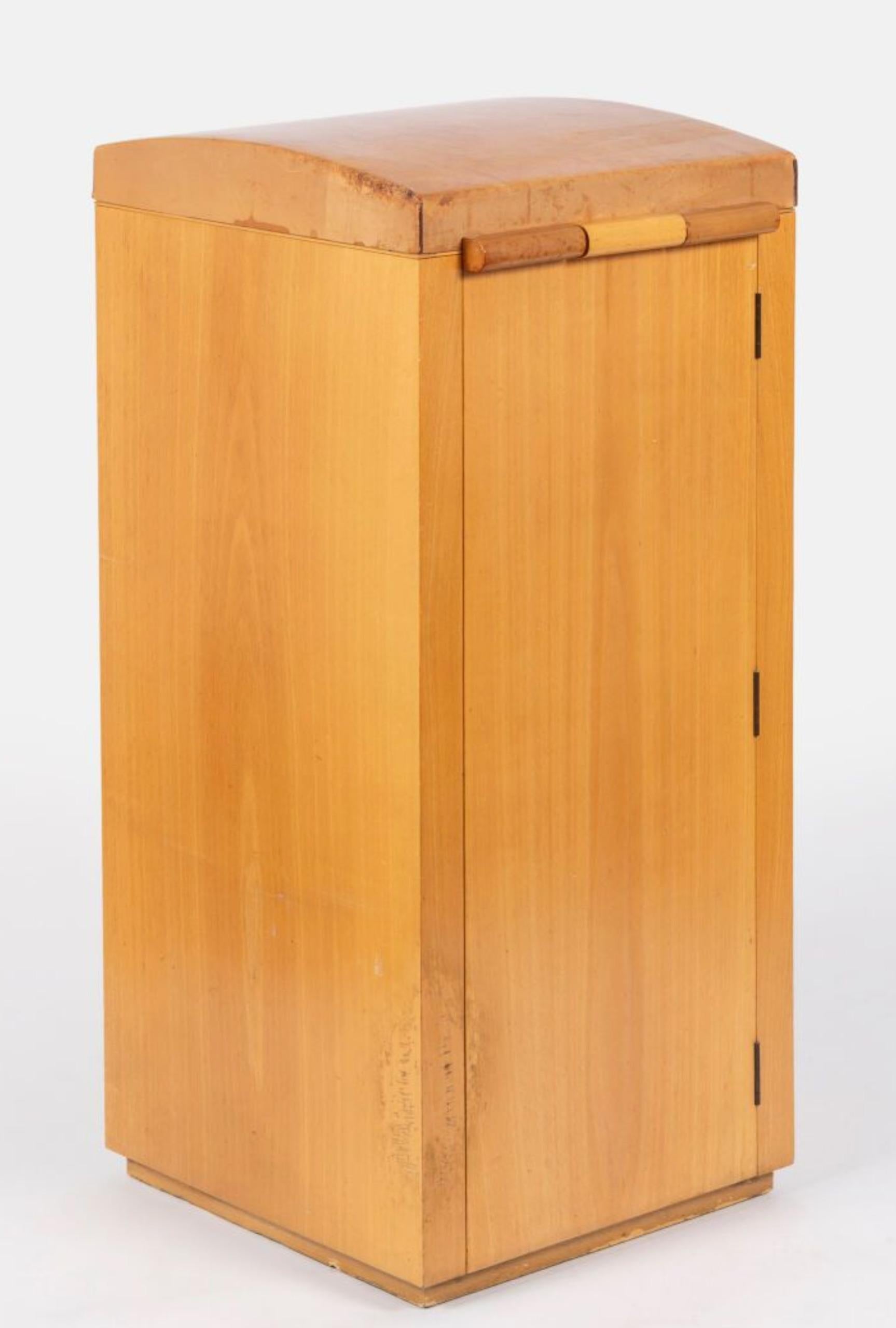 SHOE CABINET in beech, seat covered in cowhide leather, opens with a flap revealing shoe polish compartments, large drawer with 5 levels of shoe compartments, guilloché brass fittings, leather carrying handles.   Varnished beech, partially covered