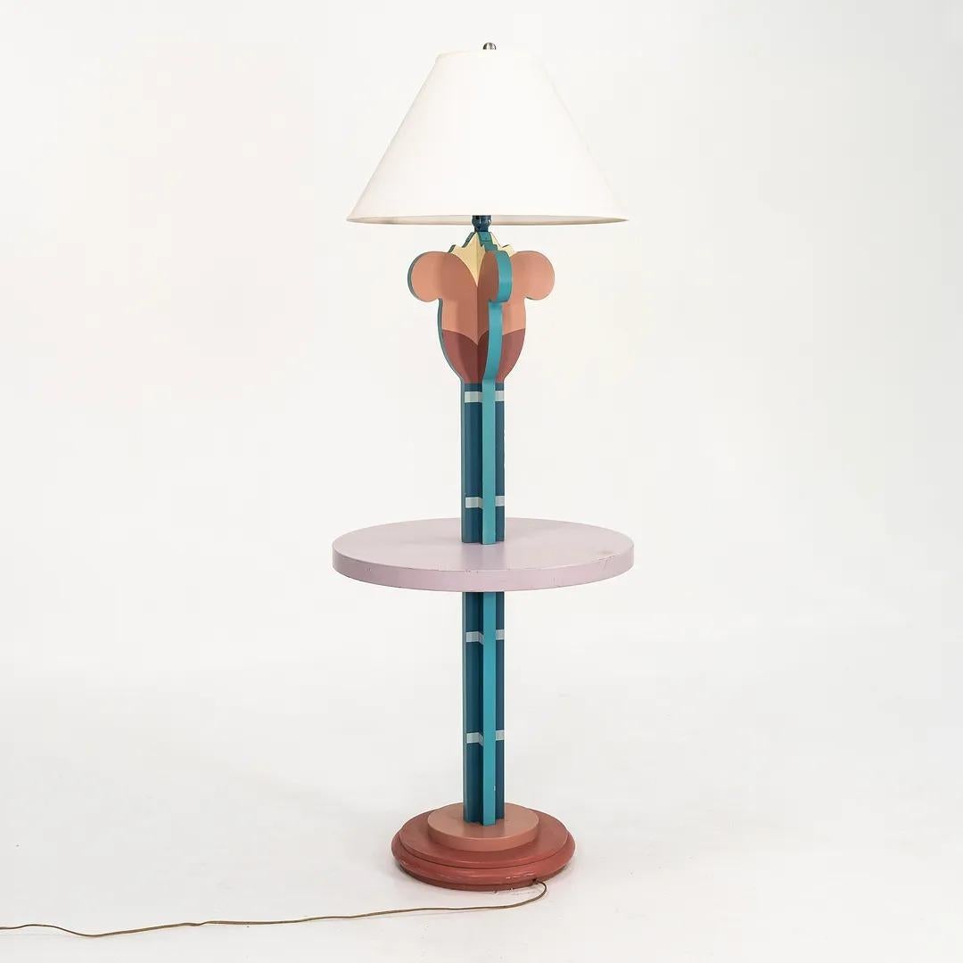 This is a prototype floor lamp, custom designed by Michael Graves for the Disney Swan Hotel in 1990. The piece is formed of enameled-metal, brass, and lacquered wood. It is a special and highly unusual piece that epitomizes Graves' furniture design