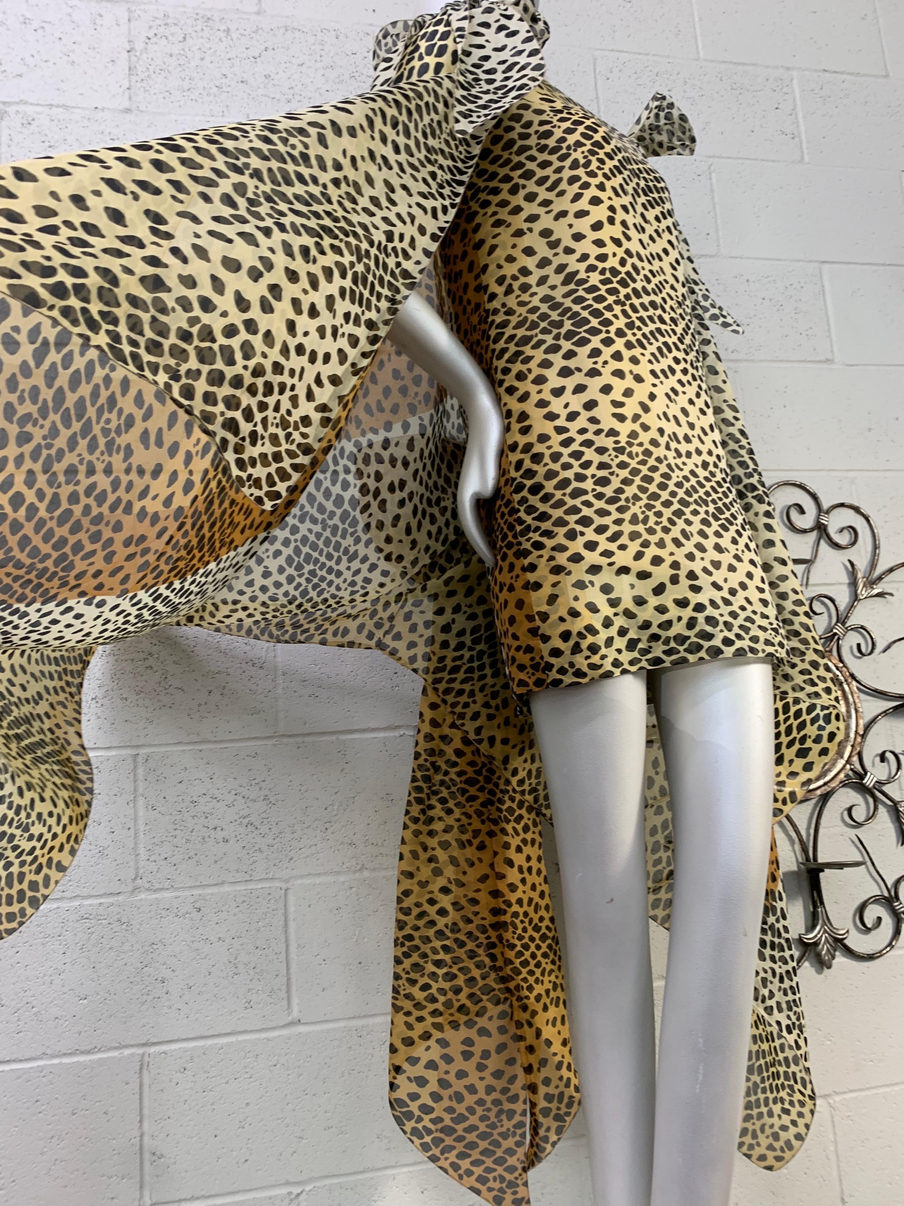 1990 Pierre Cardin Haute Couture Leopard Organza Mini Dress w Organza Cape: Brown, tan and beige leopard print organza shift dress with attached flexible wire edging for added movement. Cape design includes bow details on each shoulder and large