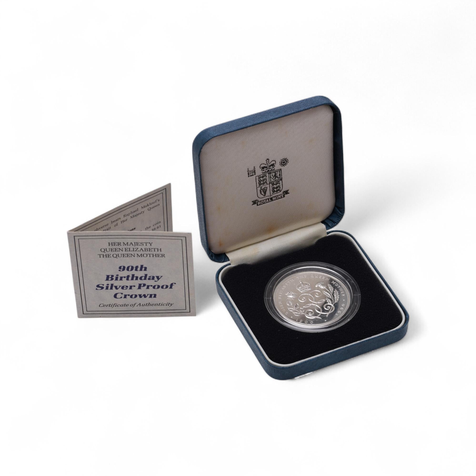 1990 Queen Mother 90th Birthday Silver Proof £5 Crown – Original Royal Mint Presentation Box & Certificate

Issued by the Royal Mint to celebrate the 90th birthday of Her Majesty Queen Elizabeth The Queen Mother on 4th August 1990, this sterling