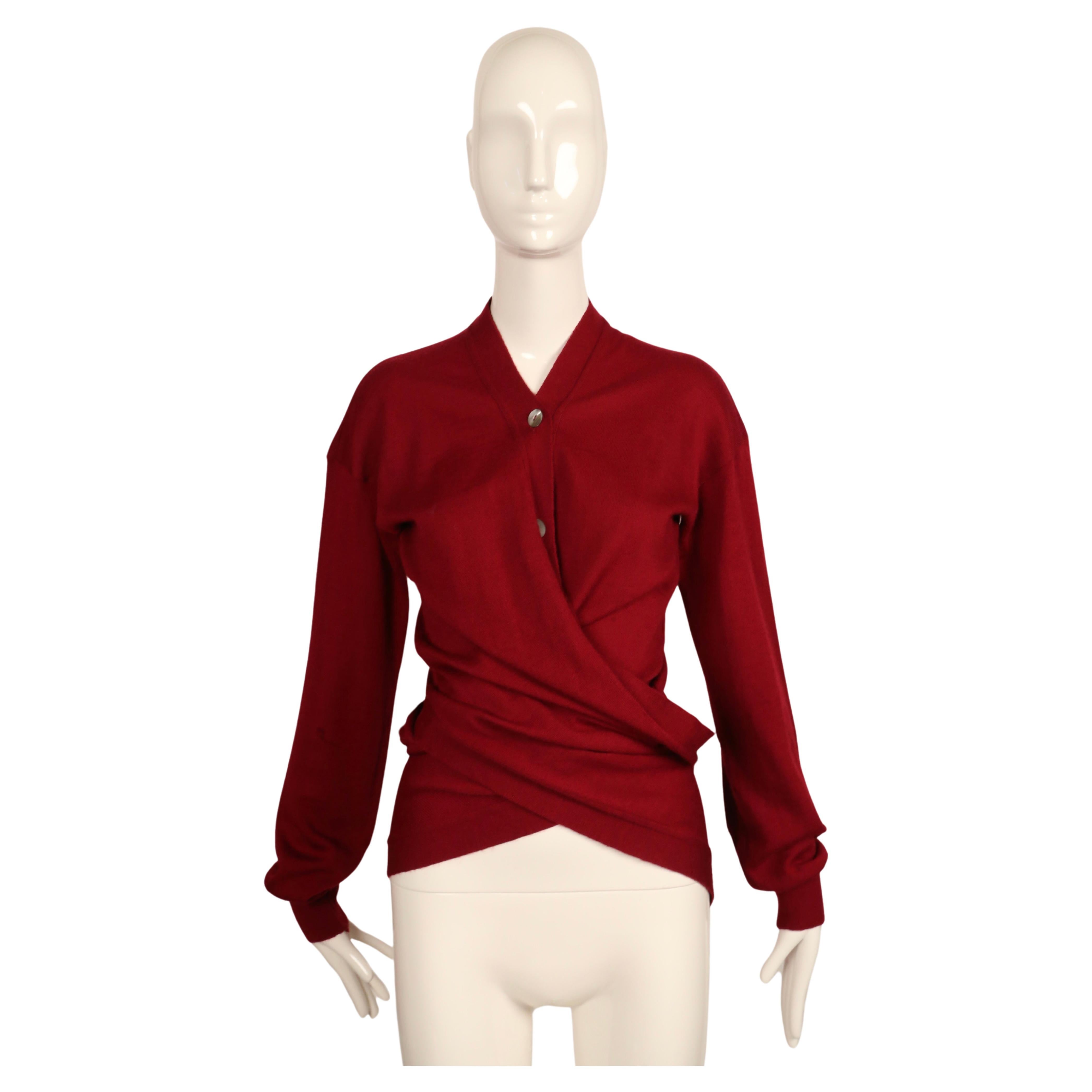 Deep cranberry wrap sweater designed by Romeo Gigli dating to approximately 1990. This piece can be found in the MET museum's costume institute archive. Labeled a size '44' however this is seems to fit a smaller size. Approximate measurements: drop