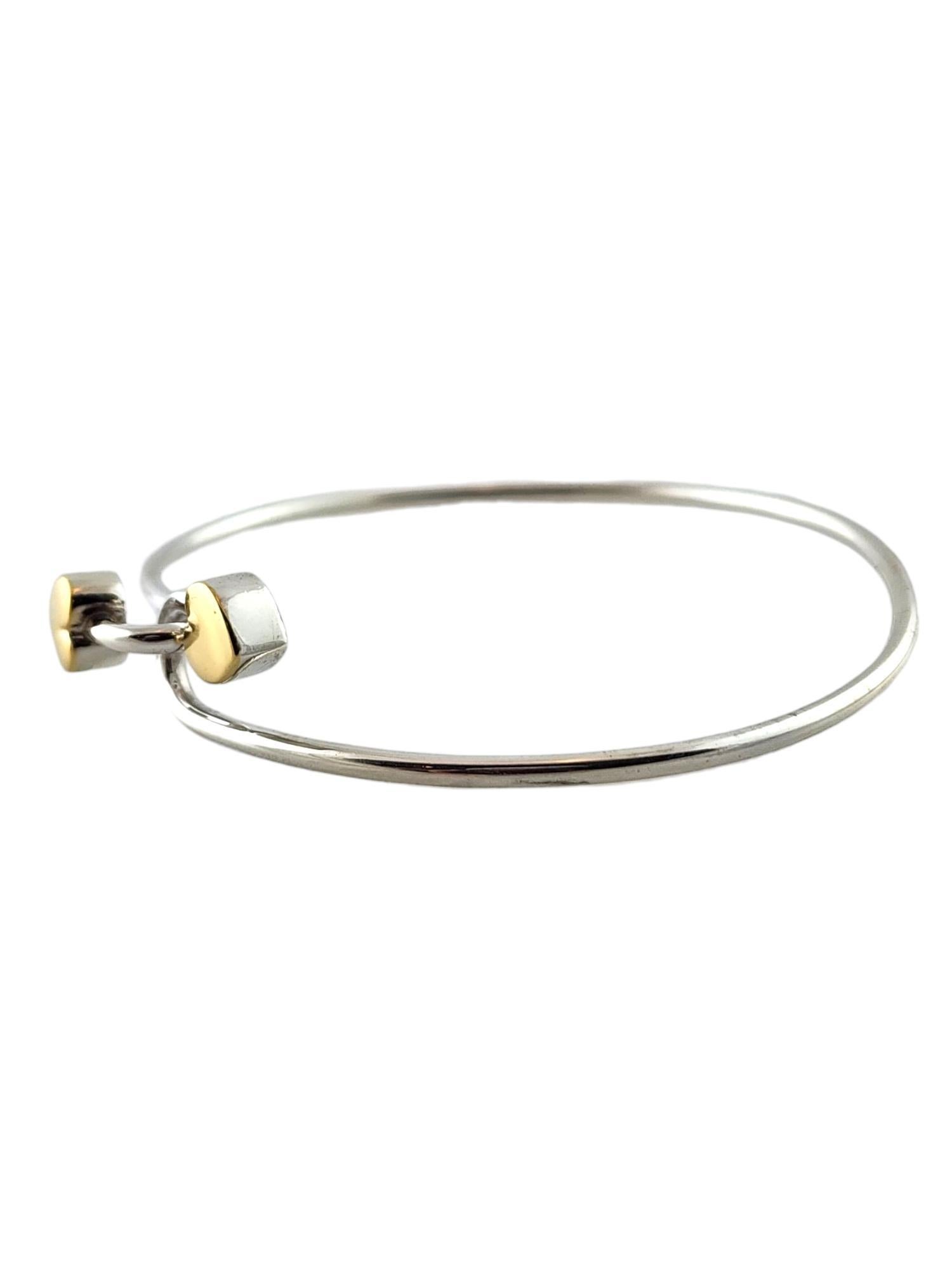 1990 Tiffany & Co Sterling Silver and 18K Yellow Gold Double Hearts Bangle Bracelet

This gorgeous bangle bracelet by designer Tiffany & Co was meticulously crafted from sterling silver with two 18K yellow gold hearts that clasp the bracelet
