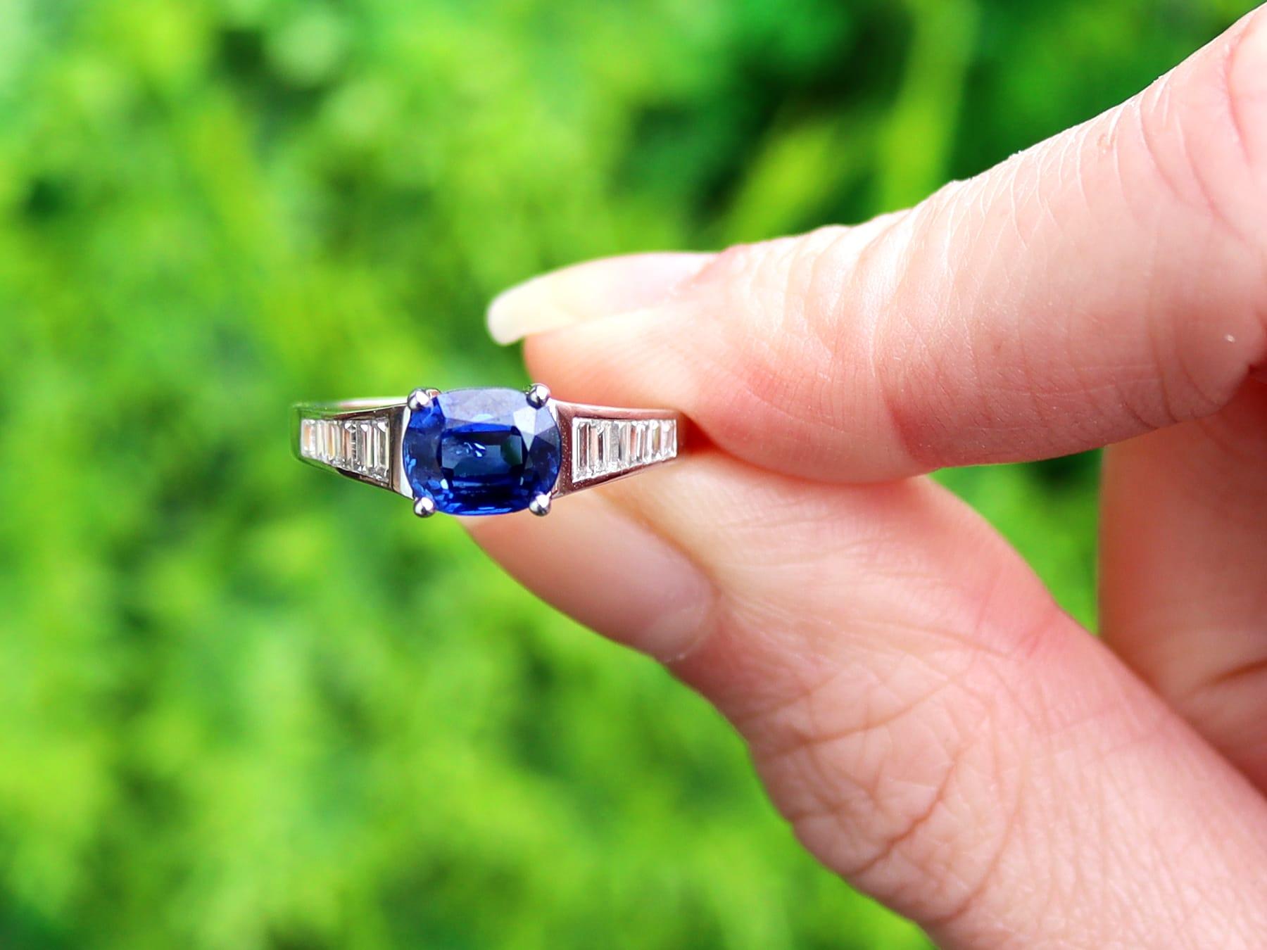 A fine and impressive vintage 1.20 carat natural blue sapphire and 0.45 carat diamond, 18 karat white gold cocktail ring; part of our vintage estate jewelry collections.

This fine and impressive oval cut sapphire and diamond ring has been crafted