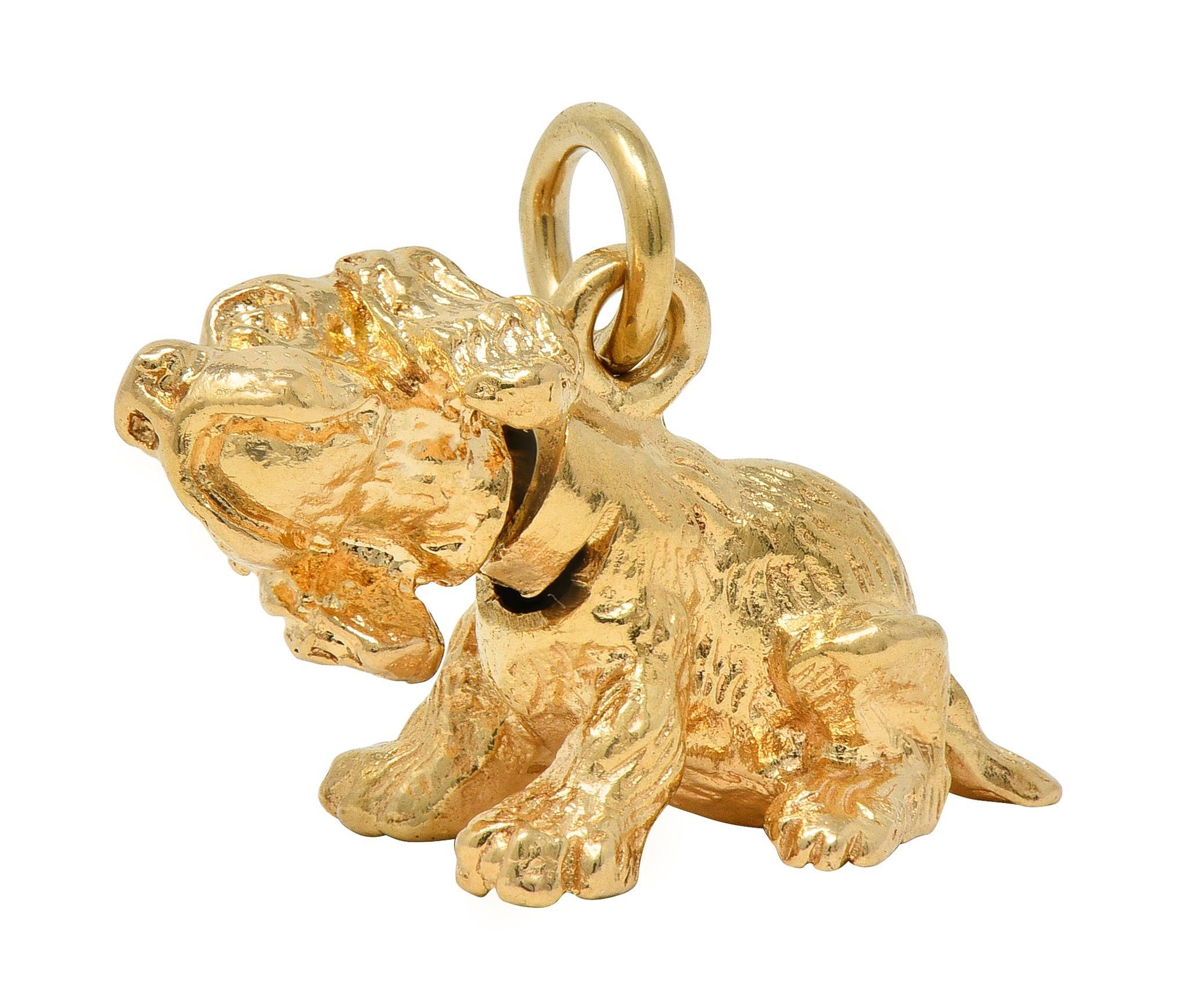 Designed as a highly rendered spaniel dog laying down
With grooved fur texture and bobble head
Completed by jump ring bale
Stamped for 14 karat gold
Circa: 1990s
Measures: 1/2 x 13/16 inches - including bale
Total Weight: 5.3 grams
Stock Number: