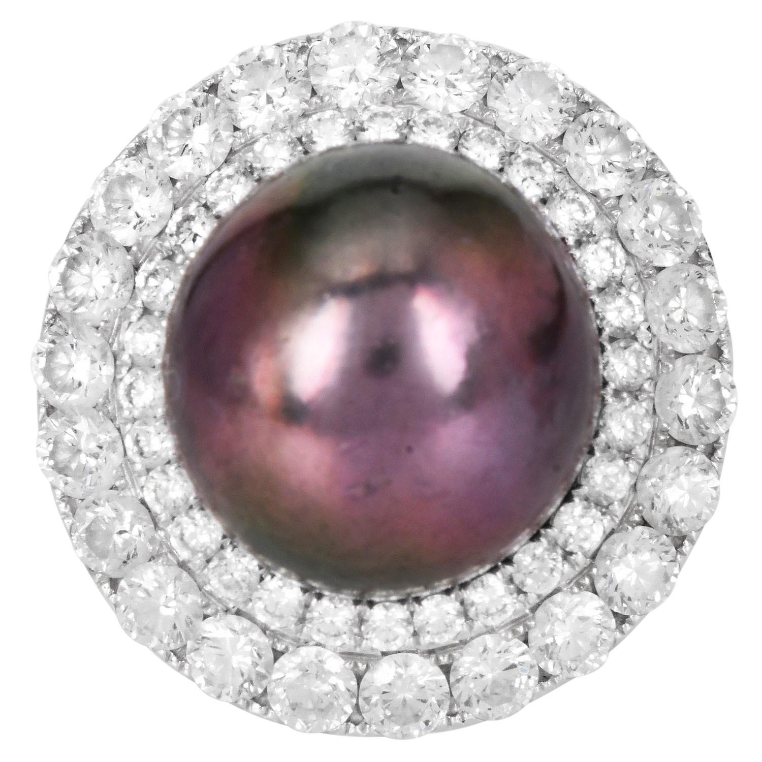 The 18K white gold cocktail ring features a captivating 15mm aubergine color genuine  South Sea pearl.

This sophisticated piece is adorned with a halo of 50 brilliant round diamonds, approximately 2.82 carats of VS clarity and G-H color,