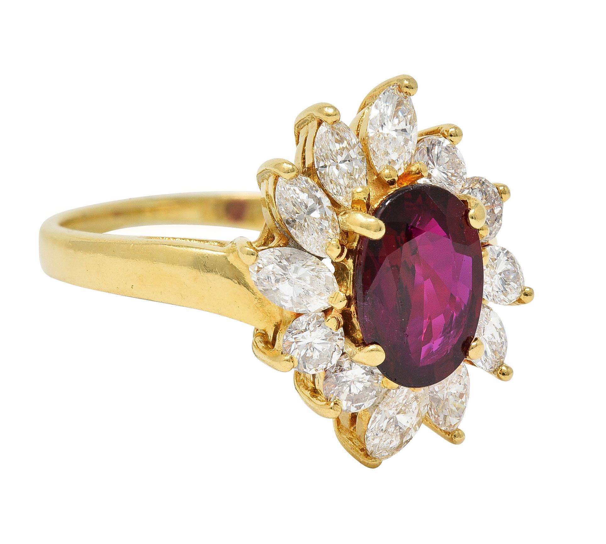Centering an oval cut ruby weighing 1.15 carats total - transparent royal red in color
Natural Thai in origin with indications of minor heat treatment - prong set
With a surround of marquise and round brilliant cut diamonds 
Weighing approximately