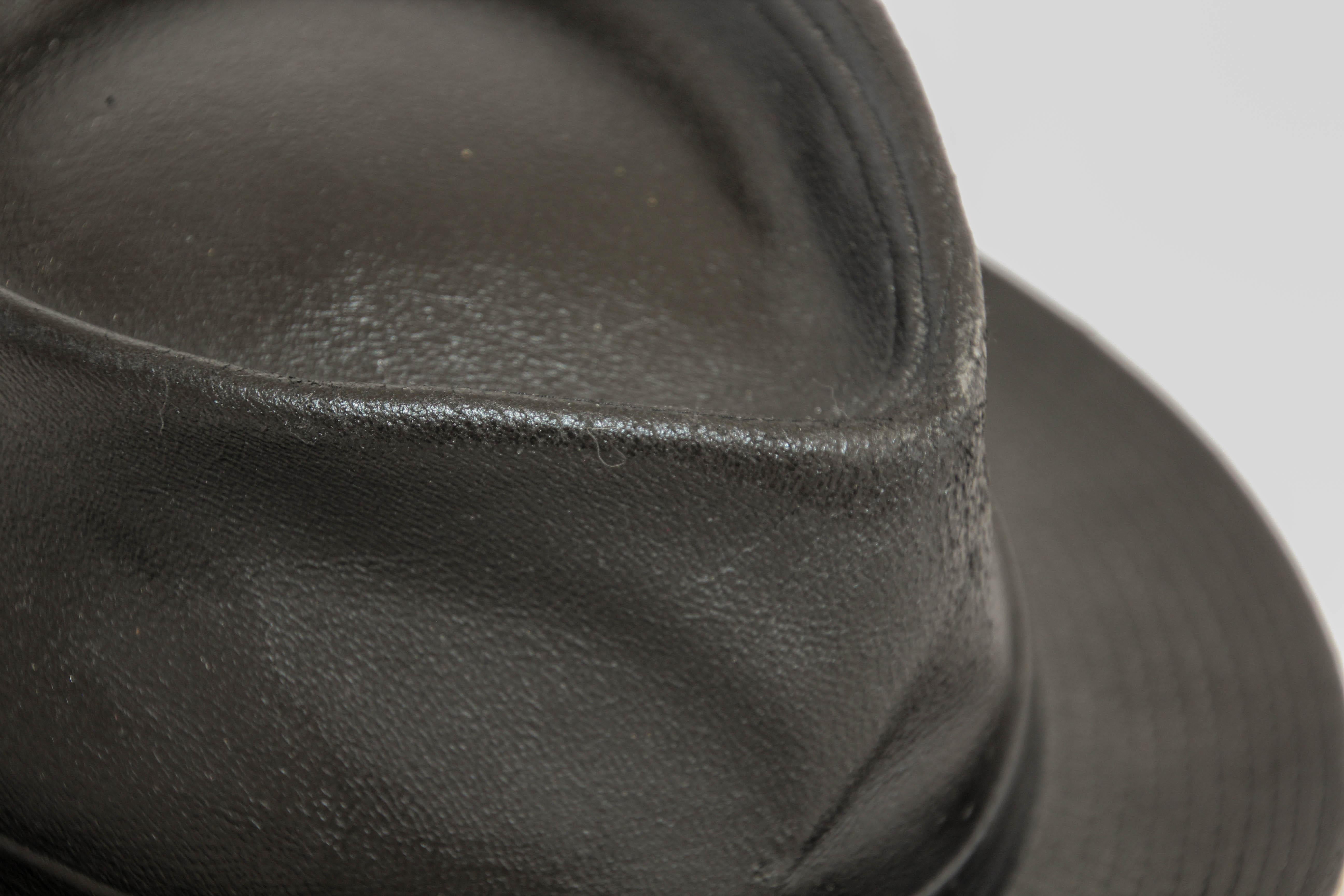 Agnes B Fedora Black Leather Hat .
Lambskin Leather Fedora Hat.
Vintage 1990s Black Leather Traditional 1920s / 30s New York Style Fedora Hat Hand crafted
A leather fedora hat with a snap brim.
Lambskin Leather Fedora Hat. 
Made of 100% lambskin