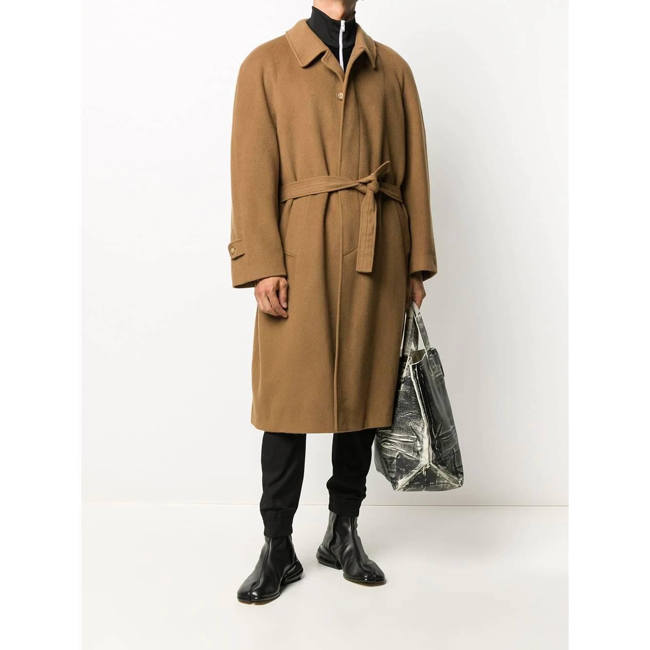 A.N.G.E.L.O. Vintage Cult hazelnut brown wool coat. It features a classic collar, concealed front button fastening and belted waist. Long sleeves, buttoned cuffs, side flap pockets and central rear vent. Fully lined.

Size: 50 IT/FR

Flat