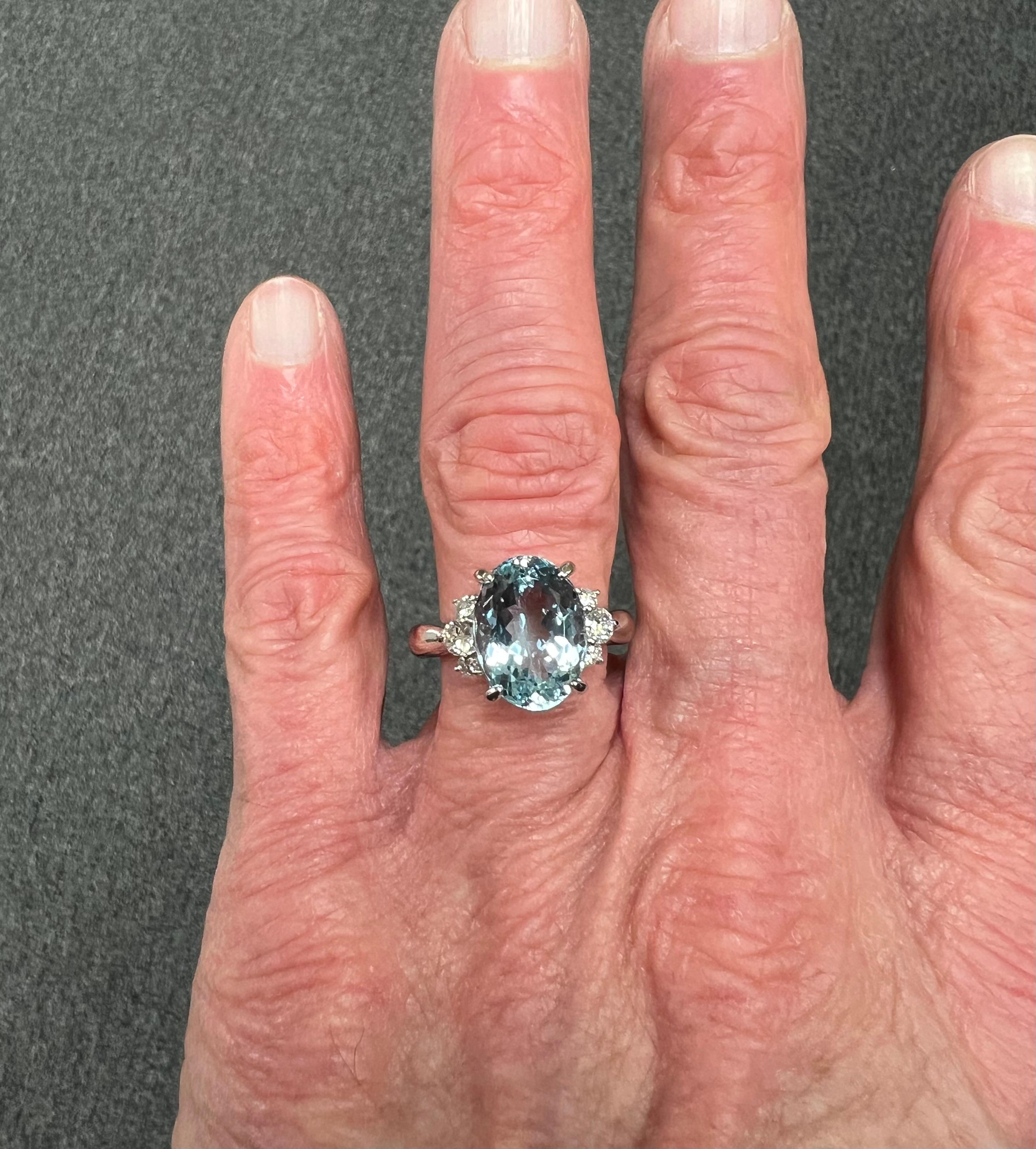 1990s Aquamarine and Diamond platinum ring, size 8.75.

The Oval Aquamarine and Diamond Platinum Ring was made in the 1990s.  Aquamarine, known for its serene blue hues is reminiscent of tranquil waters. And the color of this Aquamarine is a medium