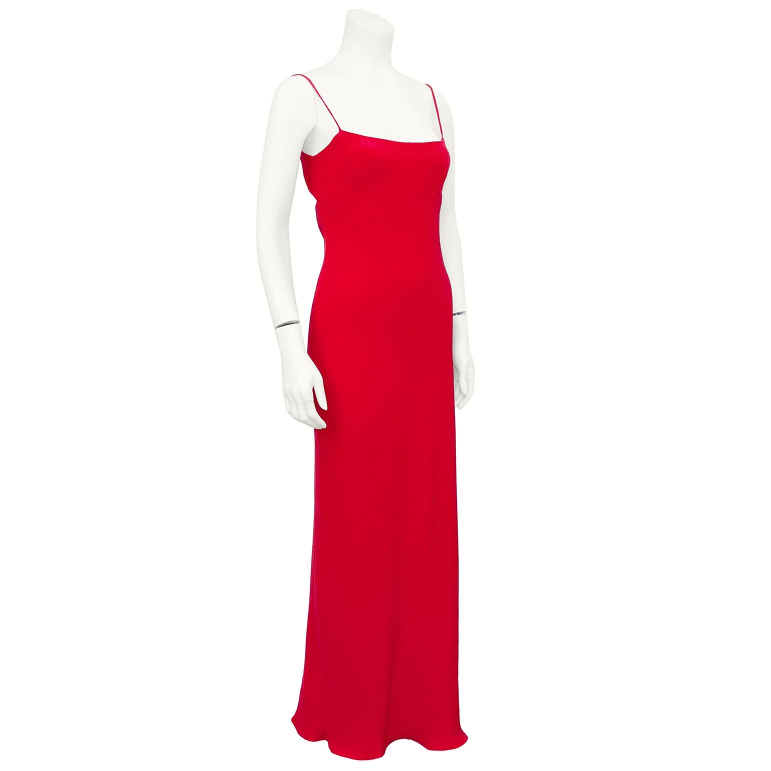 This Armani red silk gown is quintessentially 1990s. Very sexy sheath silhouette, with spaghetti straps, a square neckline and an empire waist seam with darts at bust. Open back with a tie making the bust adjustable. The expert craftsmanship and