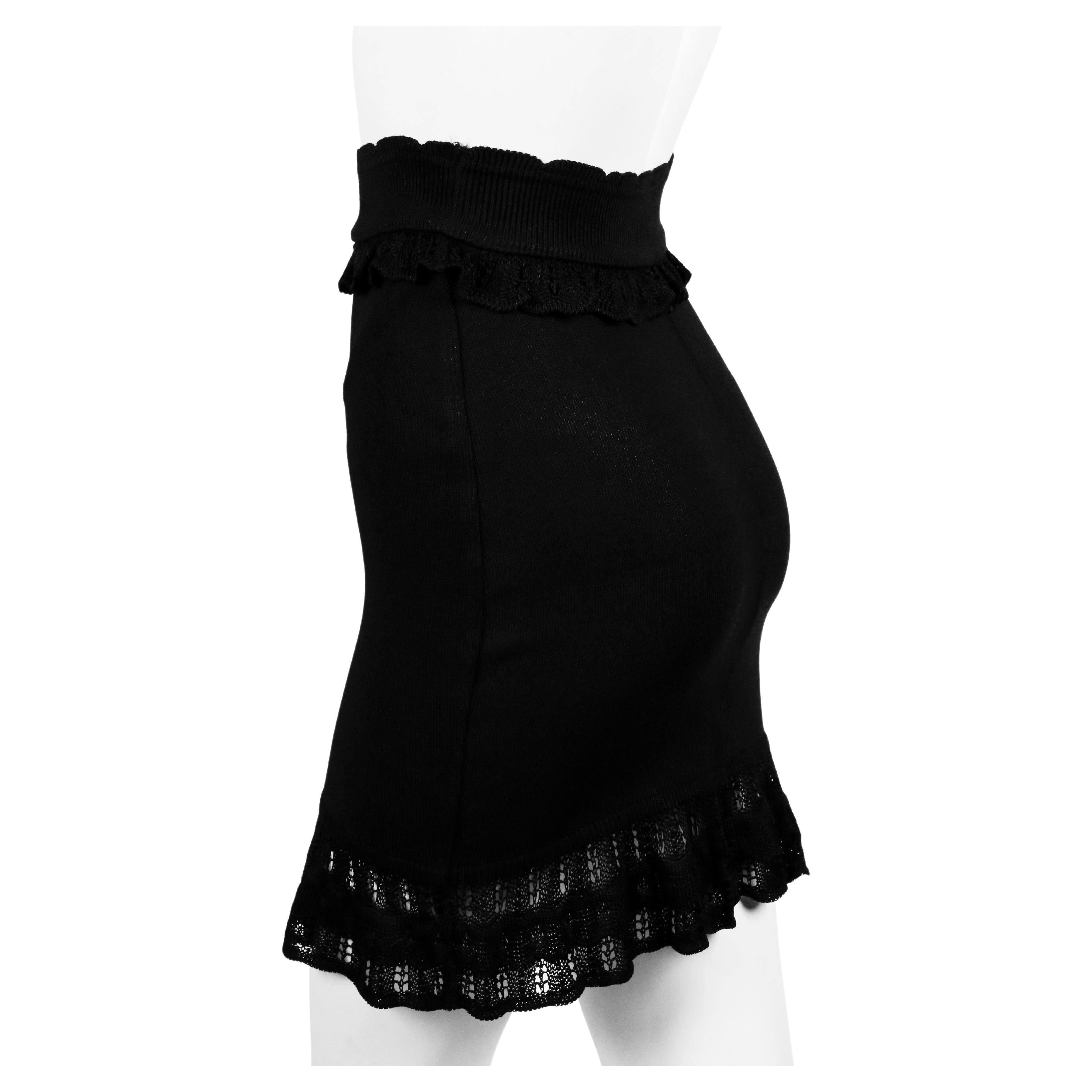 Jet-black mini skirt with ruffled trim from Azzedine Alaia dating to the 1990's. Labeled a size 'xs'. Approximate measurements: waist 22