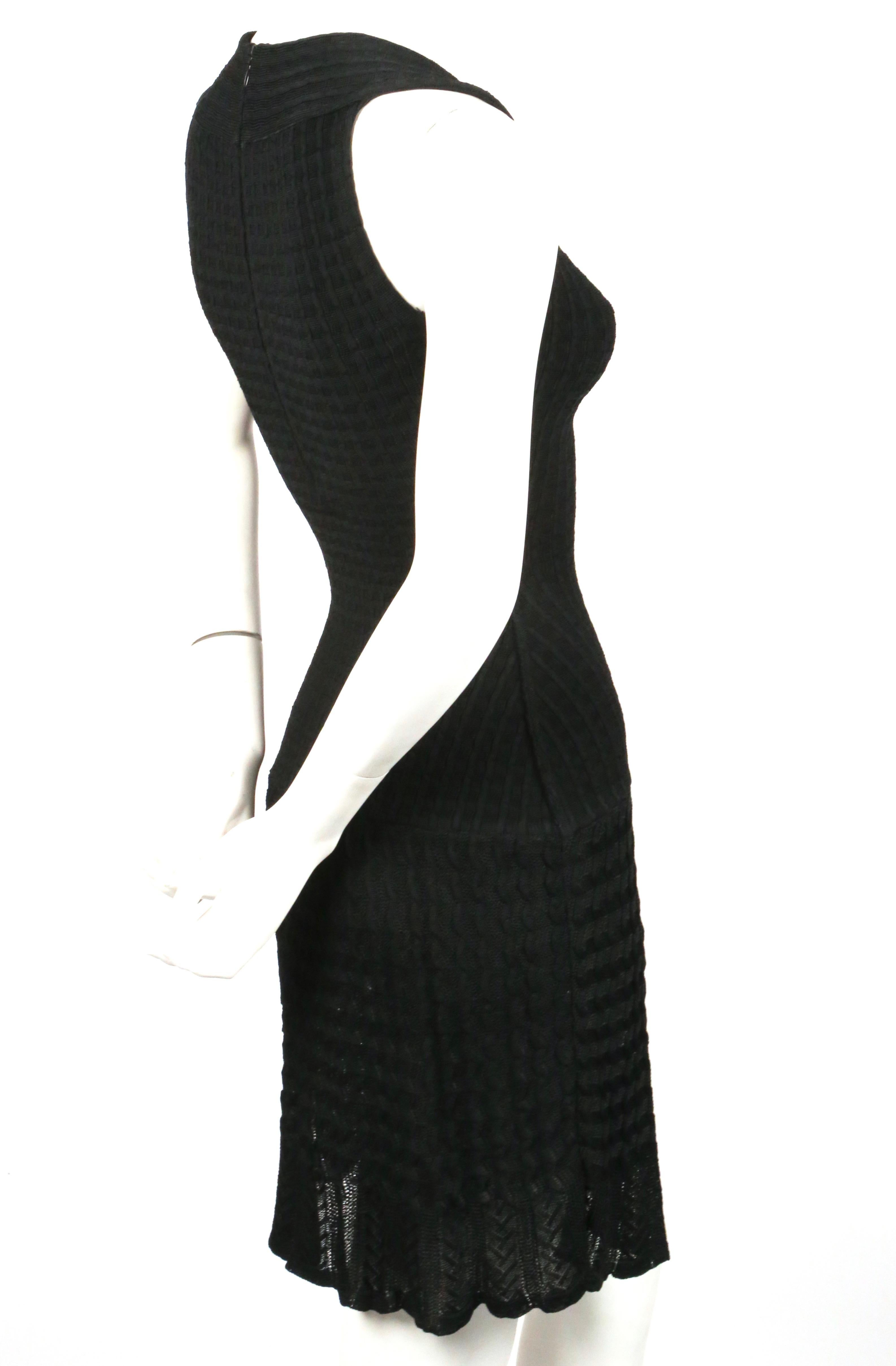 Jet black knit wool dress with semi sheer crochet detail designed by Azzedine Alaia dating to the 1990's. Labeled a size XS. Measures approximately (unstretched): 24