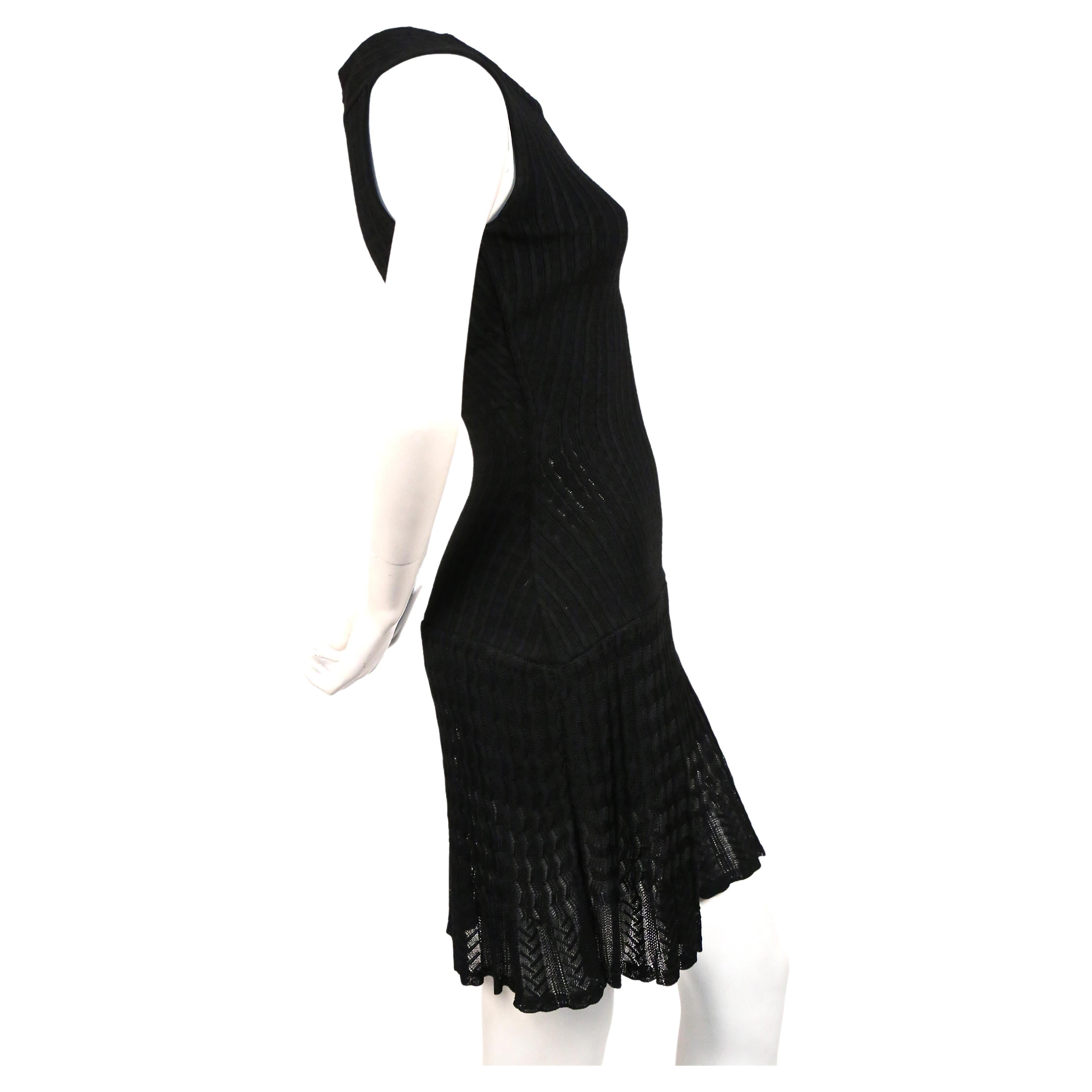 Jet black knit wool dress with semi sheer crocheted detail from Alaia dating to the 1990's. Labeled a size small. Measures approximately (unstretched): 12.75
