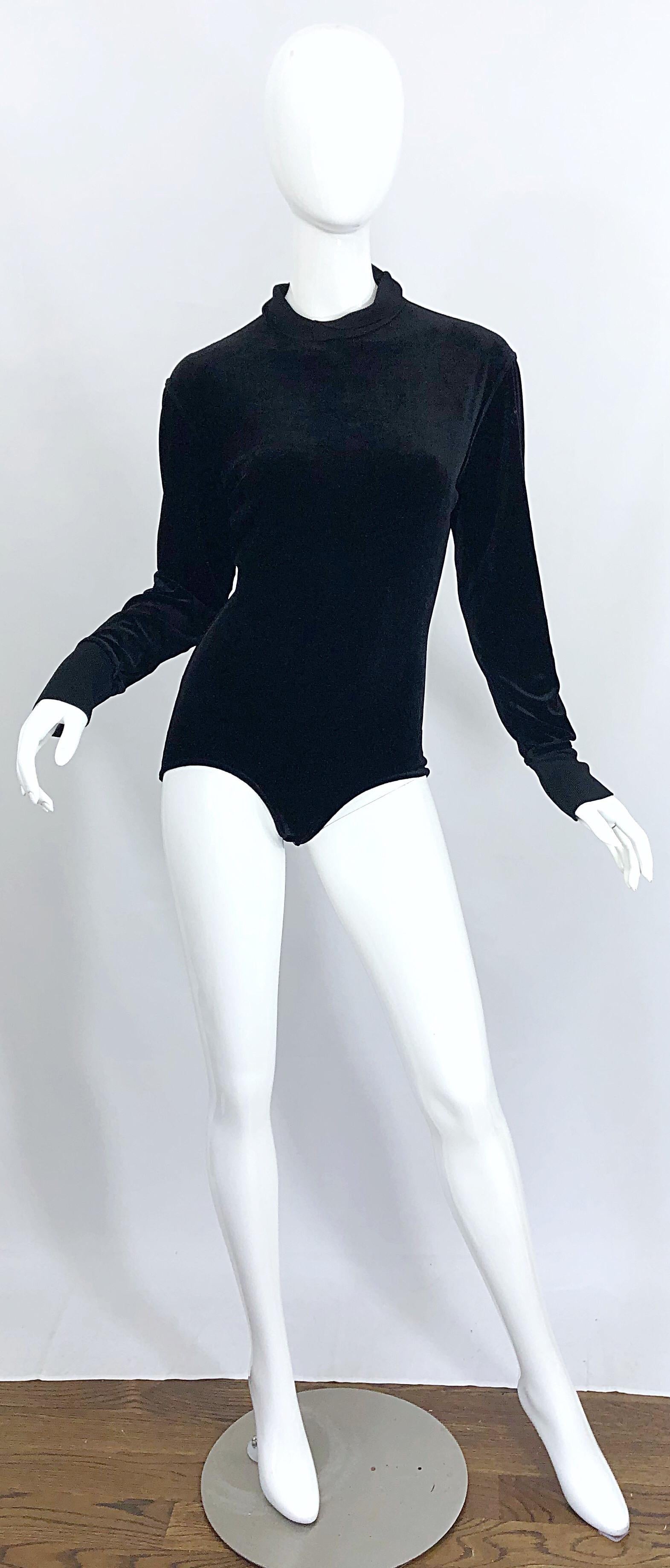 Iconic 1980s AZZEDINE ALAIA black stretch velvet one piece bodysuit! No one ever made bodysuits as well as Alaia, and this is definitely proof. Features a super soft black velvet that stretches to fit. Hidden zipper up the back collar. Hidden snaps.