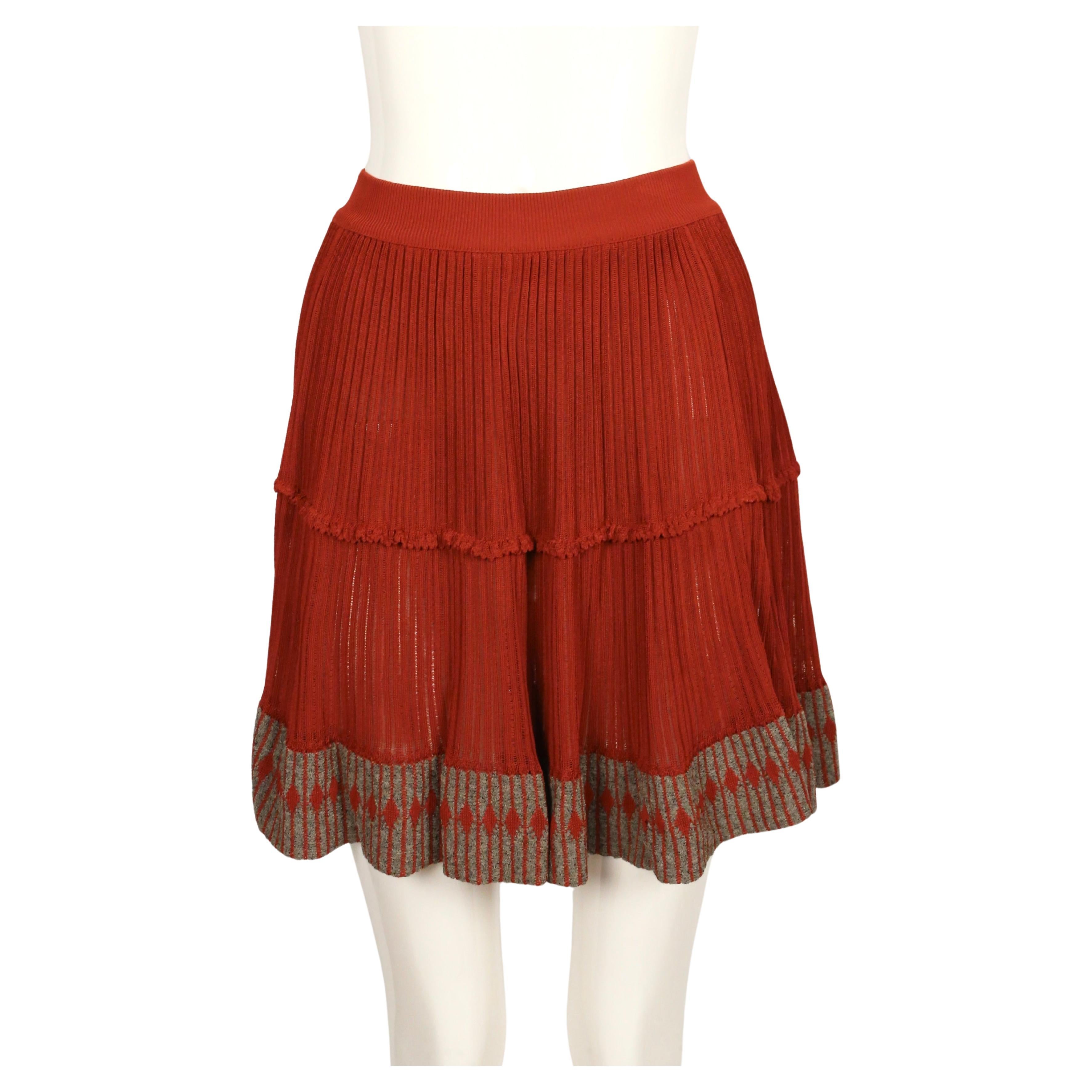 Cinnamon colored semi-sheer skirt with contrasting diamond knit detail from Azzedine Alaia dating to the 1990's. Fits a size XS or S. Approximate unstretched measurements are: waist 19