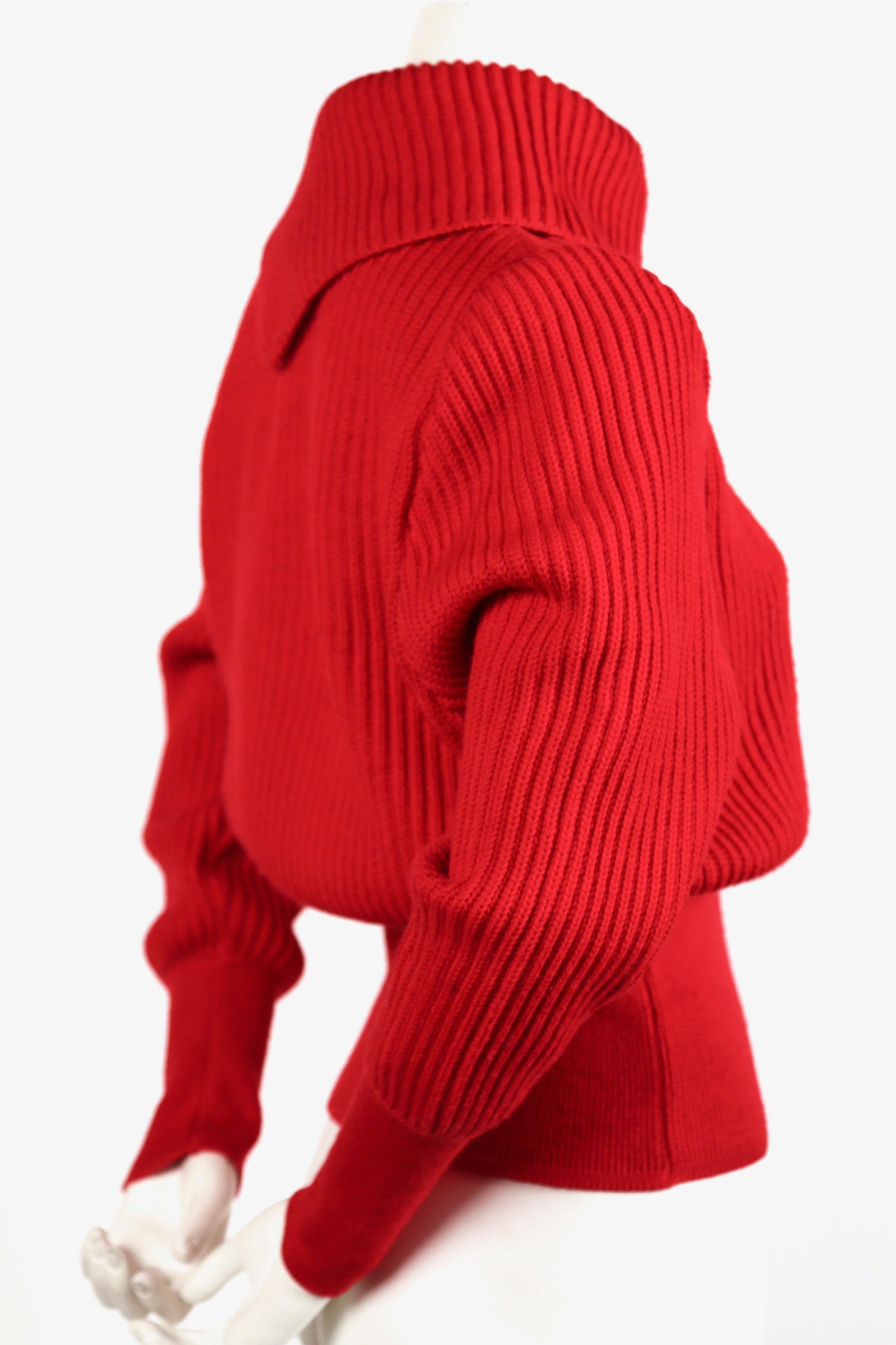 Red wool sweater with silver metal hooks designed by Azzedine Alaia dating to the late 1990's. Size 'S'. Approximate measurements: shoulder 15