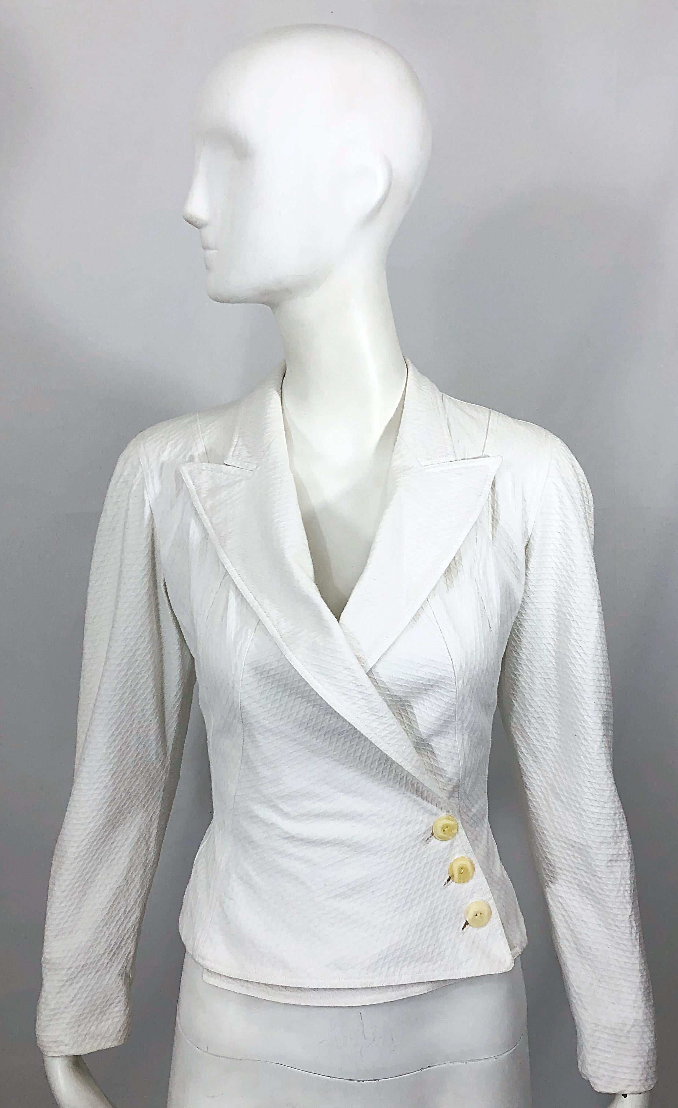 Timeless vintage 80s AZZEDINE ALAIA stark white pique cotton double breasted crop blazer jacket! Features a textured sturdy, yet soft pique cotton. Double breasted style with hidden interior button at inner waist. 
Three ivory buttons at left waist.