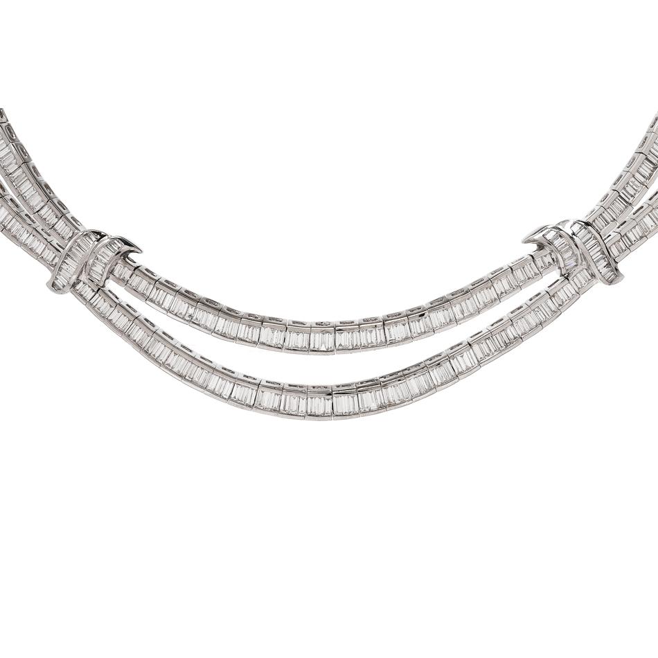 This stunning diamond choker necklace is crafted in solid 18-karat white gold, weighing 111.11 grams and measuring 19” long. Channel-set with 585 baguette-cut diamonds collectively weighing approximately, 26.68 carats, graded G-H color and VS1
