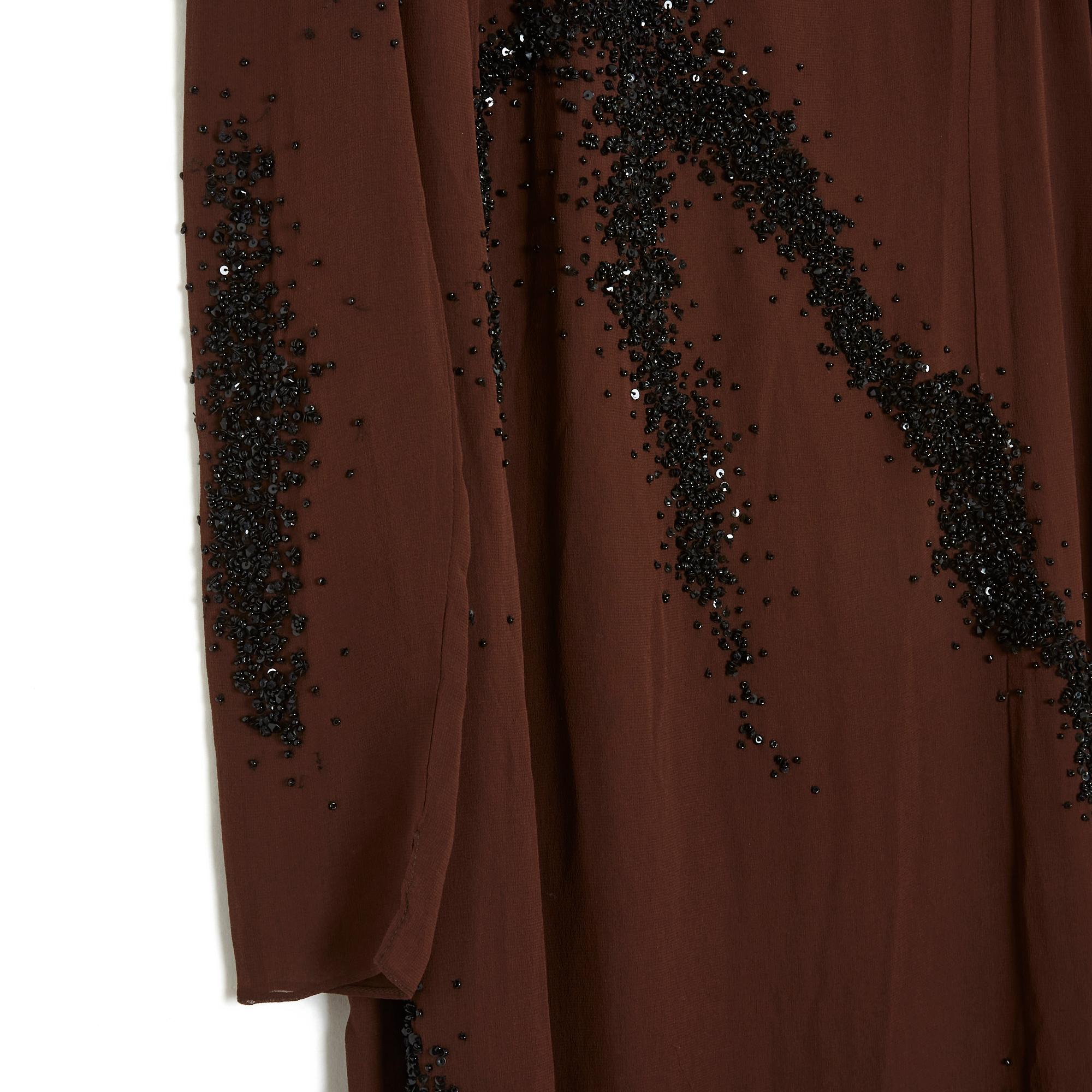 Balmain circa 1990 long dress in brown silk crepe embroidered with black glass beads, asymmetrical collar, long sleeves (unlined, transparent), wrap-around style skirt with an opening on the front, lined with silk crepe on the body, button closure a