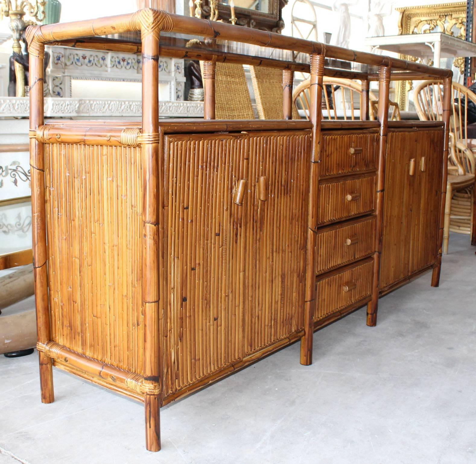 1990s bamboo Spanish sideboard with glass top. Four drawers in the centre and two doors on either side.