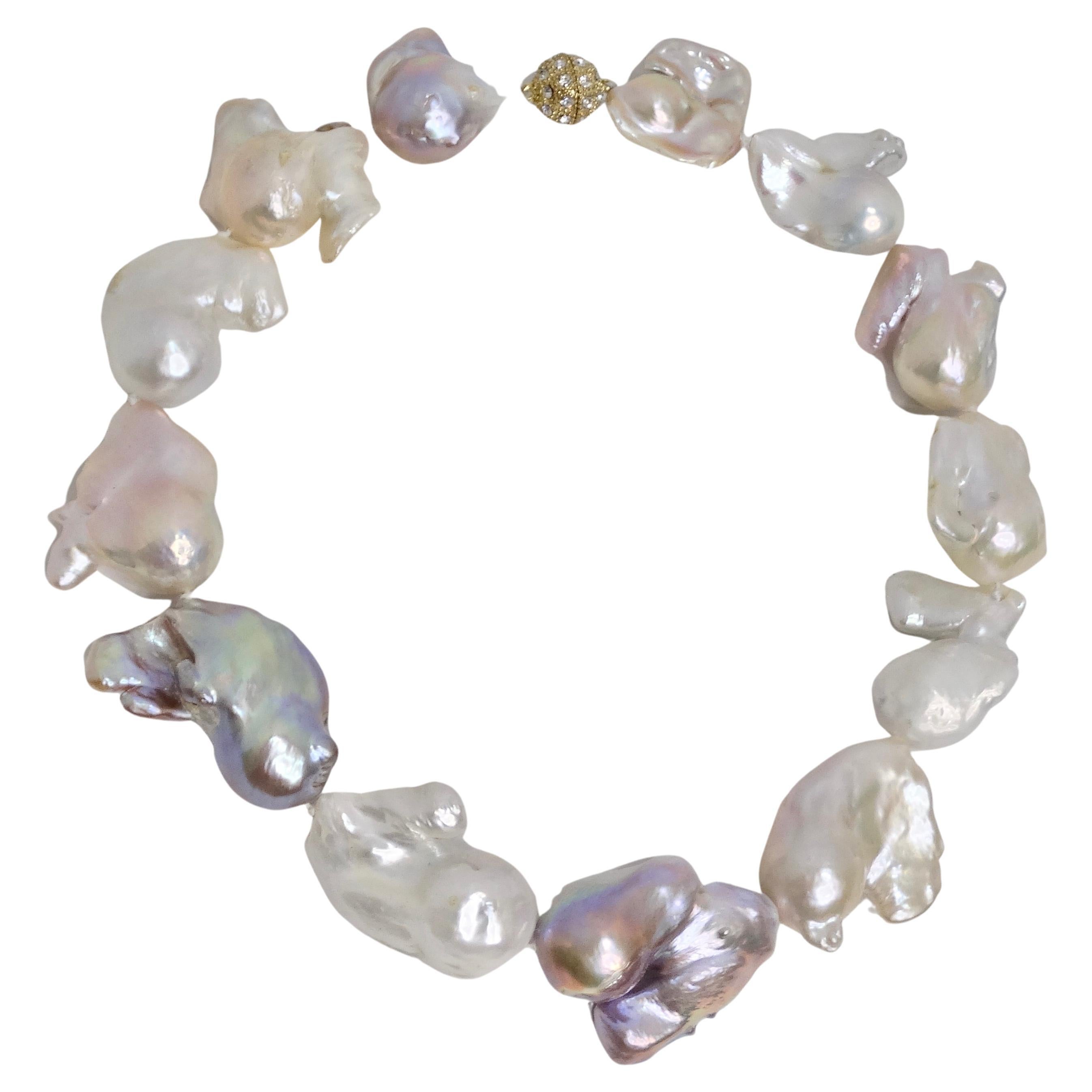 Elevate your style with the understated luxury of this classic choker-style necklace. Crafted from the most exquisite large iridescent fireball pearls, this necklace is a true testament to nature's artistry. Each pearl is a unique masterpiece,