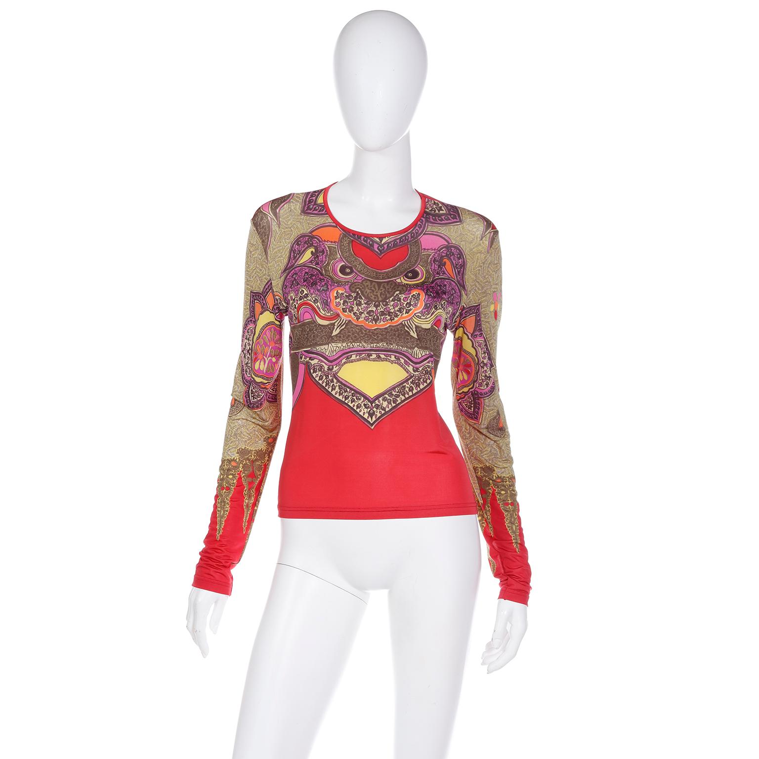 This unique vintage 1990s Christian Lacroix Bazar stretch knit top features a colorful Chinese dragon print in various shades of purple, red, green, yellow, pink, orange and a green grey. The top has Lacroix's signature tattoo type long sleeves. The