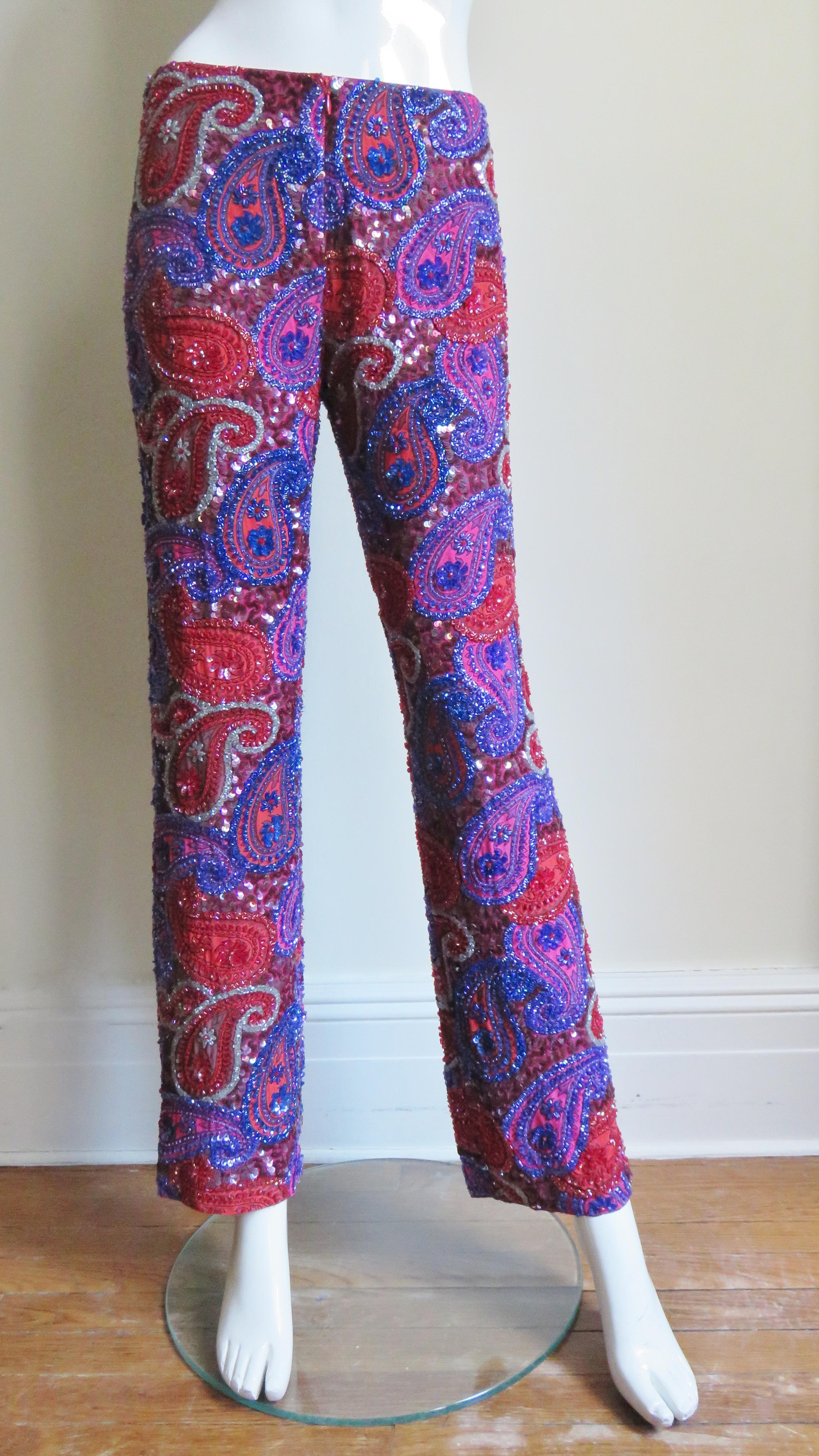 Fabulous red, lilac and purple paisley pattern beaded silk pants from Christiana.  The pants are mid rise with straight legs, a front zipper closing and lined in red silk.  They are entirely covered in glass beads matching and outlining the silk