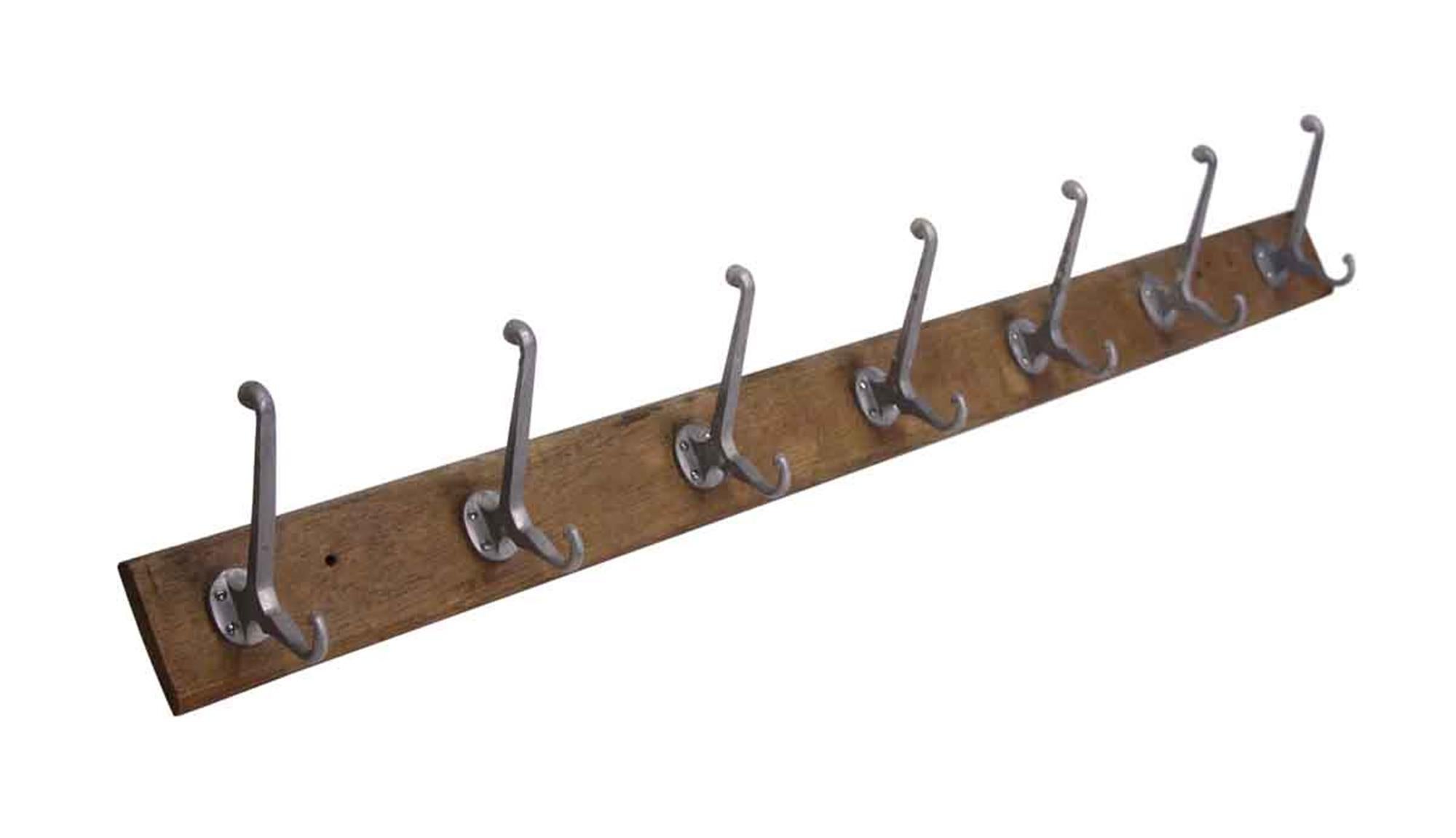 1990s Belgium wall mounted coat rack with seven hooks on a wooden plank. This can be seen at our 400 Gilligan St location in Scranton, PA.