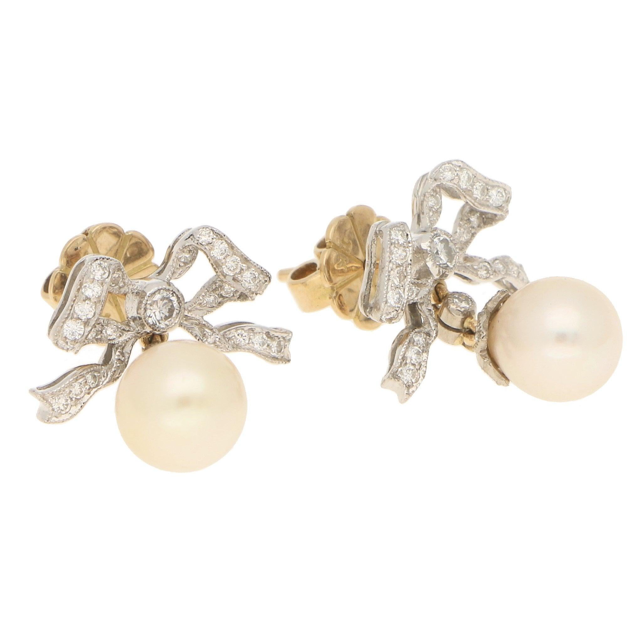 Cultured pearls of a light cream colour, approximately 9mm. Diamonds approximately 0.40 carats in total, F/G colour, VS/SI clarity.
A pair of Belle Epoque style cultured pearl and diamond bow drop earrings in 18-karat white and yellow gold, circa