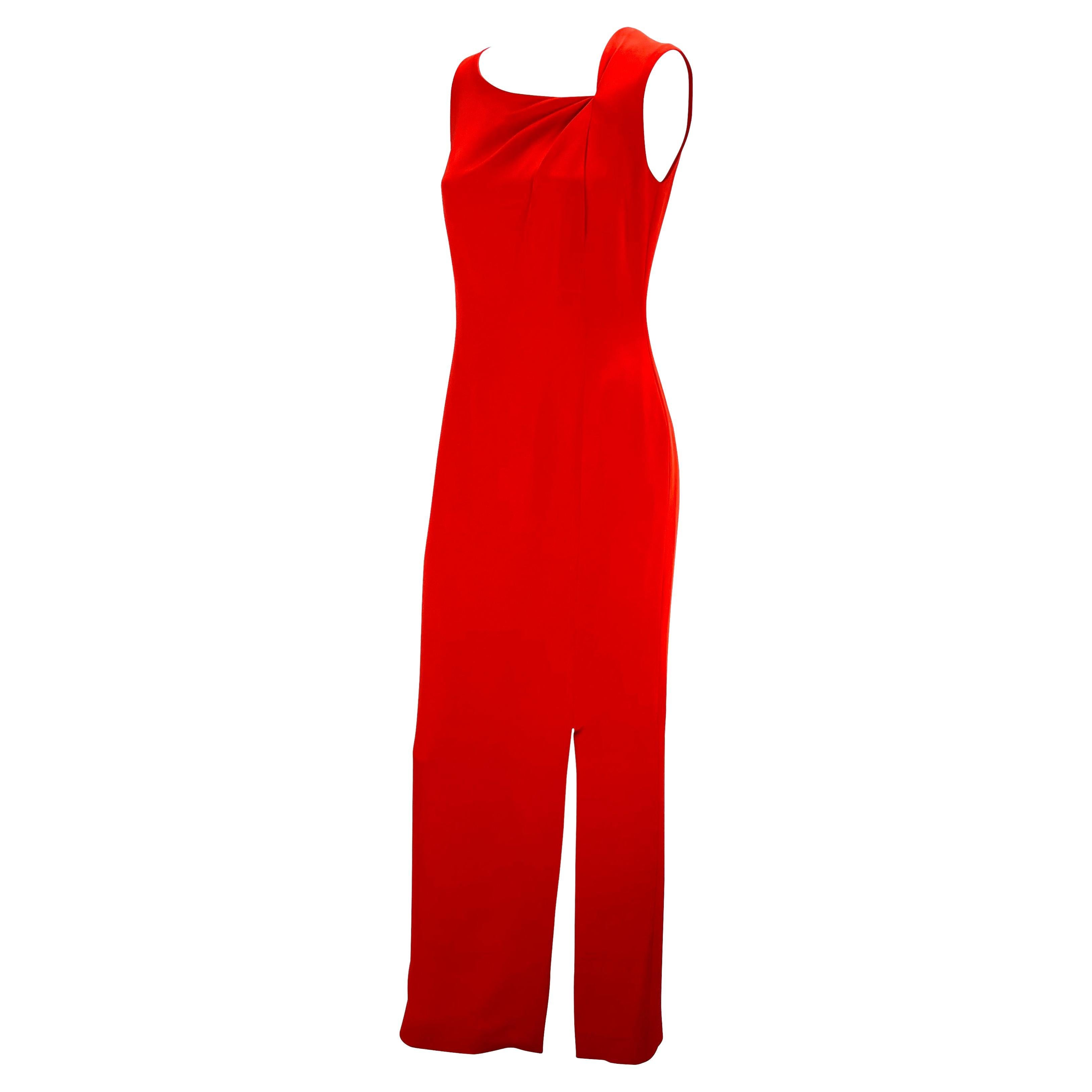 Presenting a beautiful red full-length sleeveless Bill Blass Couture gown. From the 1990s, this elegant and timeless column style gown features an asymmetric neckline with gathered fabric to create dimension. The dress is made complete with a