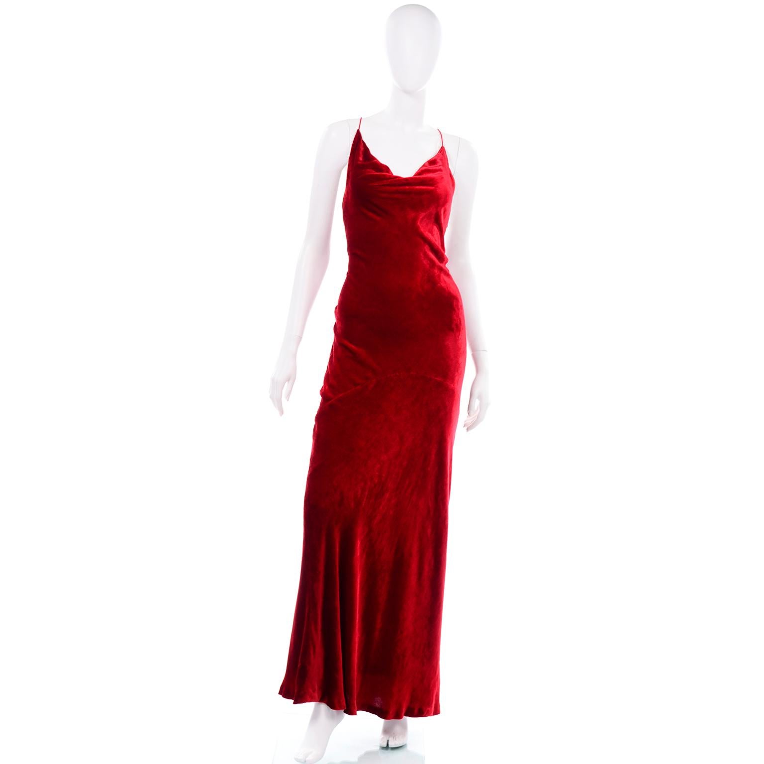 This gorgeous vintage 1990's Bill Blass red velvet bias cut evening gown has thin spaghetti straps that cross in the back and a draped cowl neckline.  This lovely dress has beautiful red silk lining and a low back. There is a metal hook and eye