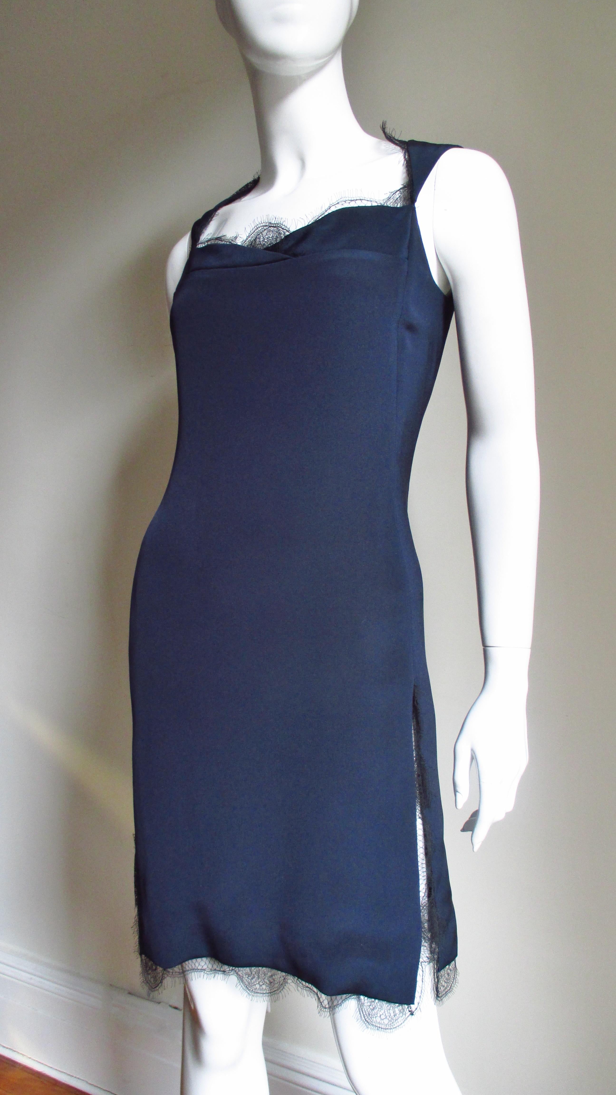 A beautiful navy blue silk dress from Bill Blass. It is semi fitted with a sweetheart neckline and 12