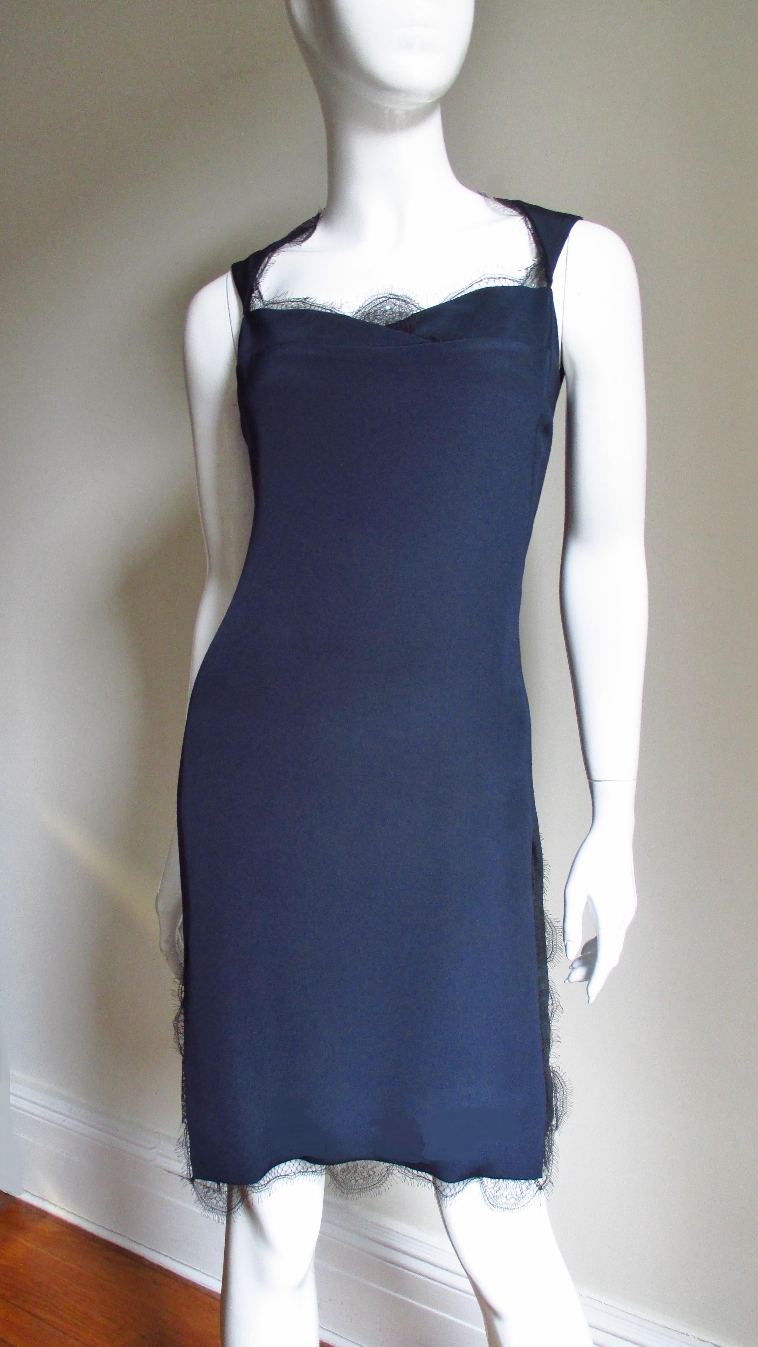 A beautiful rich navy blue silk dress from Bill Blass.   It has a sweetheart neckline create by 2 horiozntally inset angular pieces the cross at center front and 2 triangular front straps that form a crew neckline in the back.  There are no side