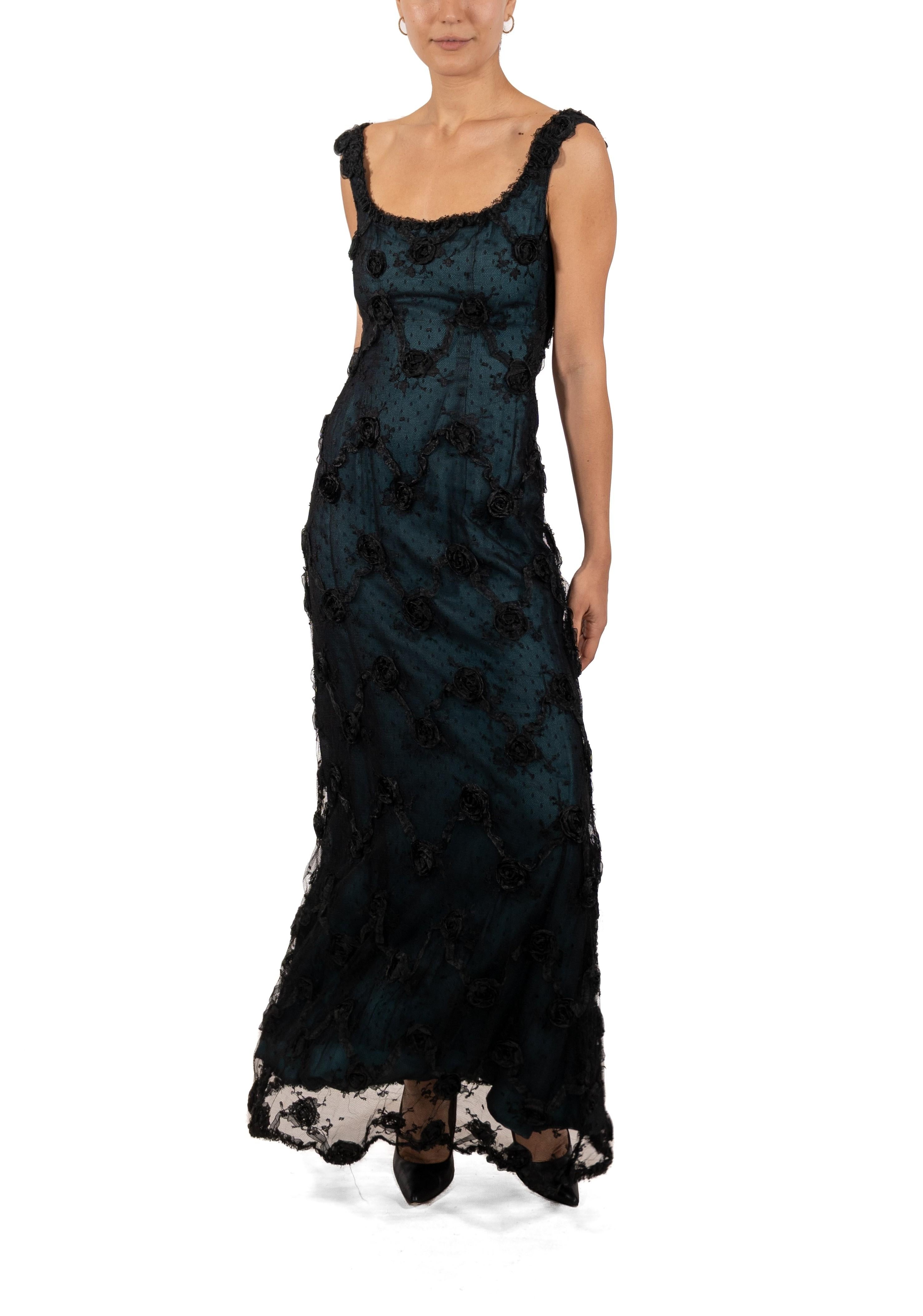 This gown retains no label, however the amount of hand-finishing points to Haute Couture or custom made quality, fully lined in silk. 1990S Black Chantilly Lace Underlined In Teal Silk Satin Gown With Organza Ribbon Flowers 