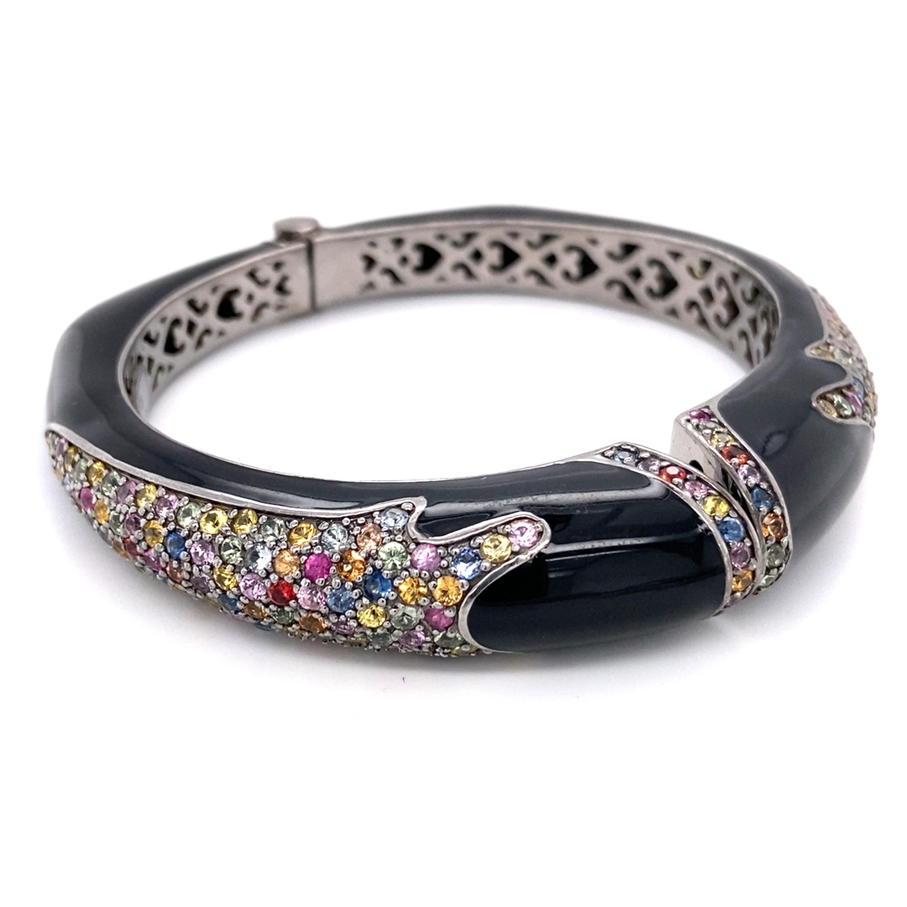 Item Details: 
Metal: Sterling Silver
Weight: 72 grams 
Measurements: 2.5 inches across x 2 inches high (Inside Bracelet)

Item Features: 
This beautiful multi-gem stone bangle features 5 carats of assorted sapphire, topaz, and quartz all crafted in