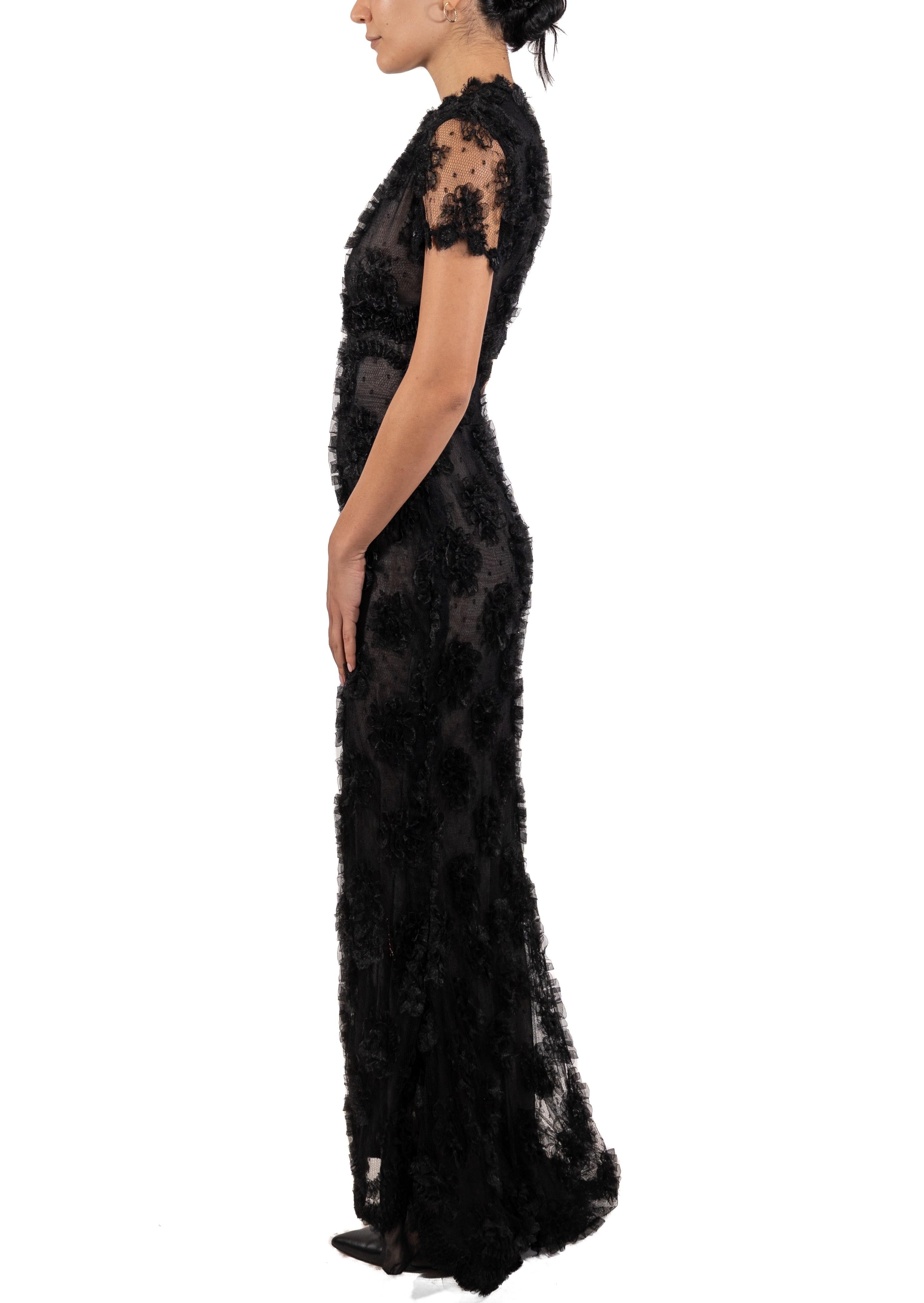 This gown retains no label, however the amount of hand-finishing points to Haute Couture or custom made quality, fully lined in silk. 1990S Black Silk Chantilly Lace Short Sleeved Gown With Ribbon Flowers 