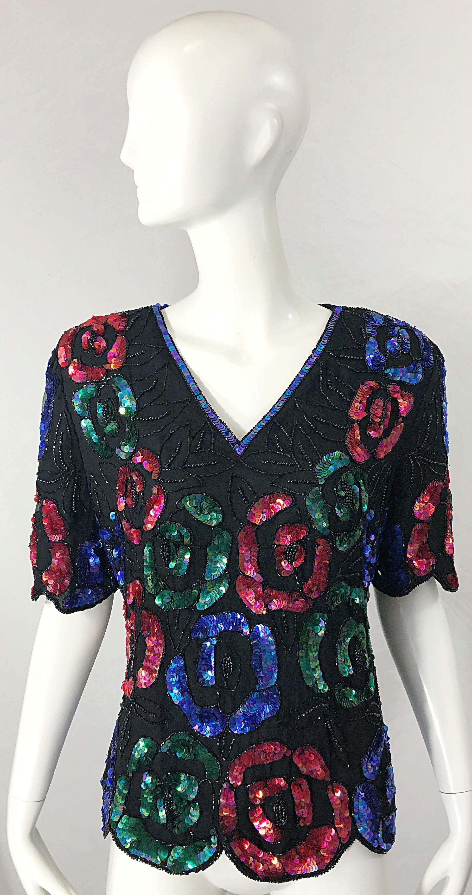 Beautiful early 90s black silk chiffon beaded and sequined blouse top ! Features thousands of hand-sewn sequins and beads throughout. Colorful flowers in red, blue and green with Iridescent sequins around the collar. Hidden zipper up the back with