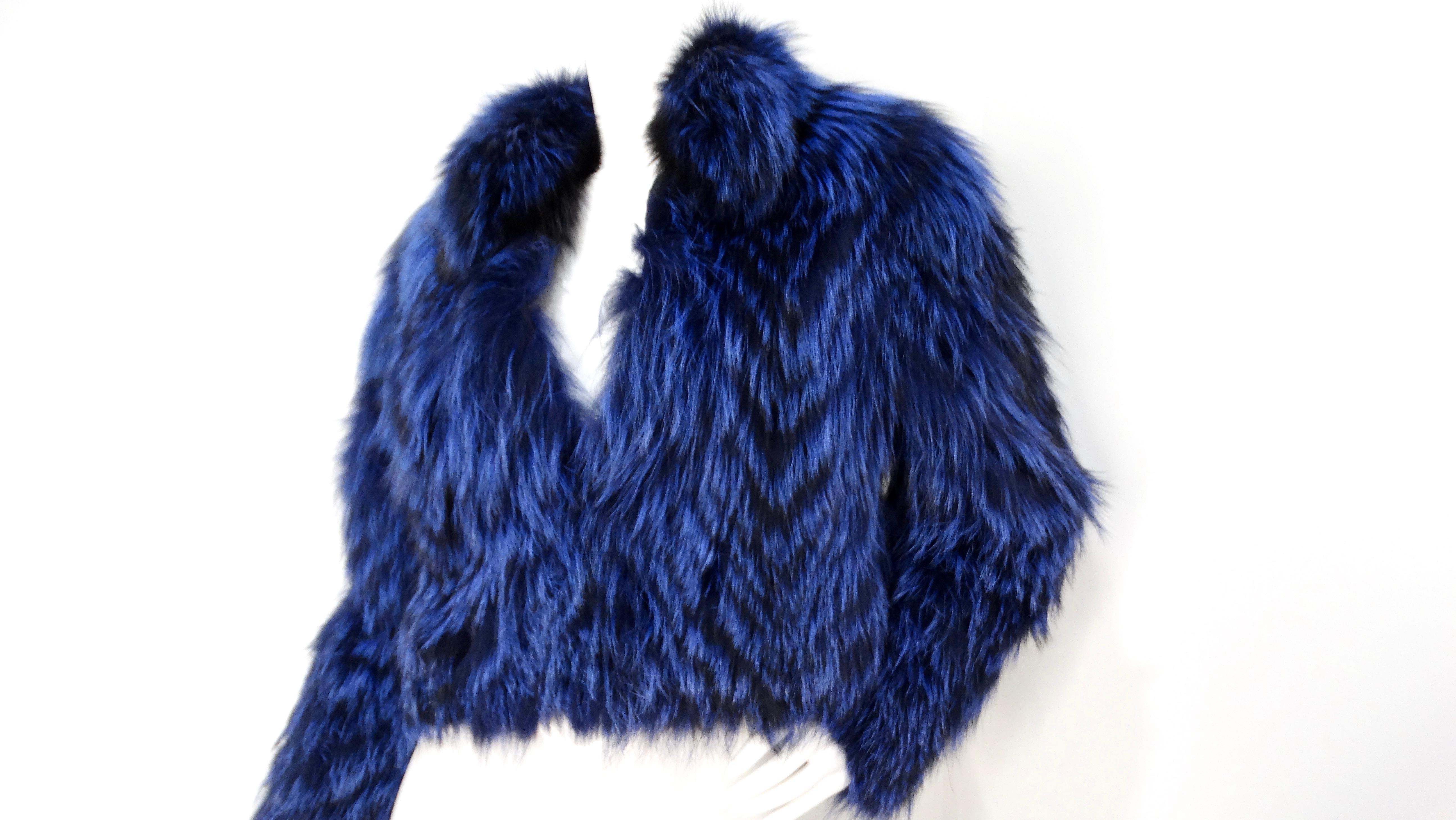 Introducing the stunning 1990s Blue & Black Fox Fur Cropped Jacket, a show-stopping piece that commands attention. This luxurious cropped jacket features a captivating blend of bright cobalt blue and deep black fox fur, creating a bold color